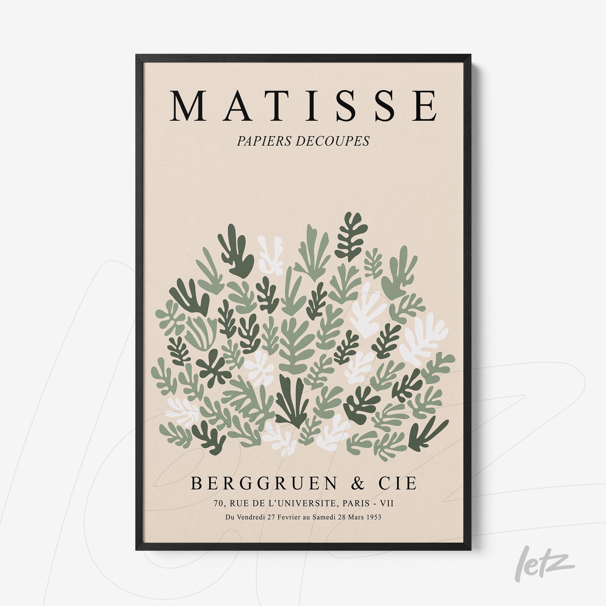 framed modern art featuring green and white leaves on a light background with black frame
