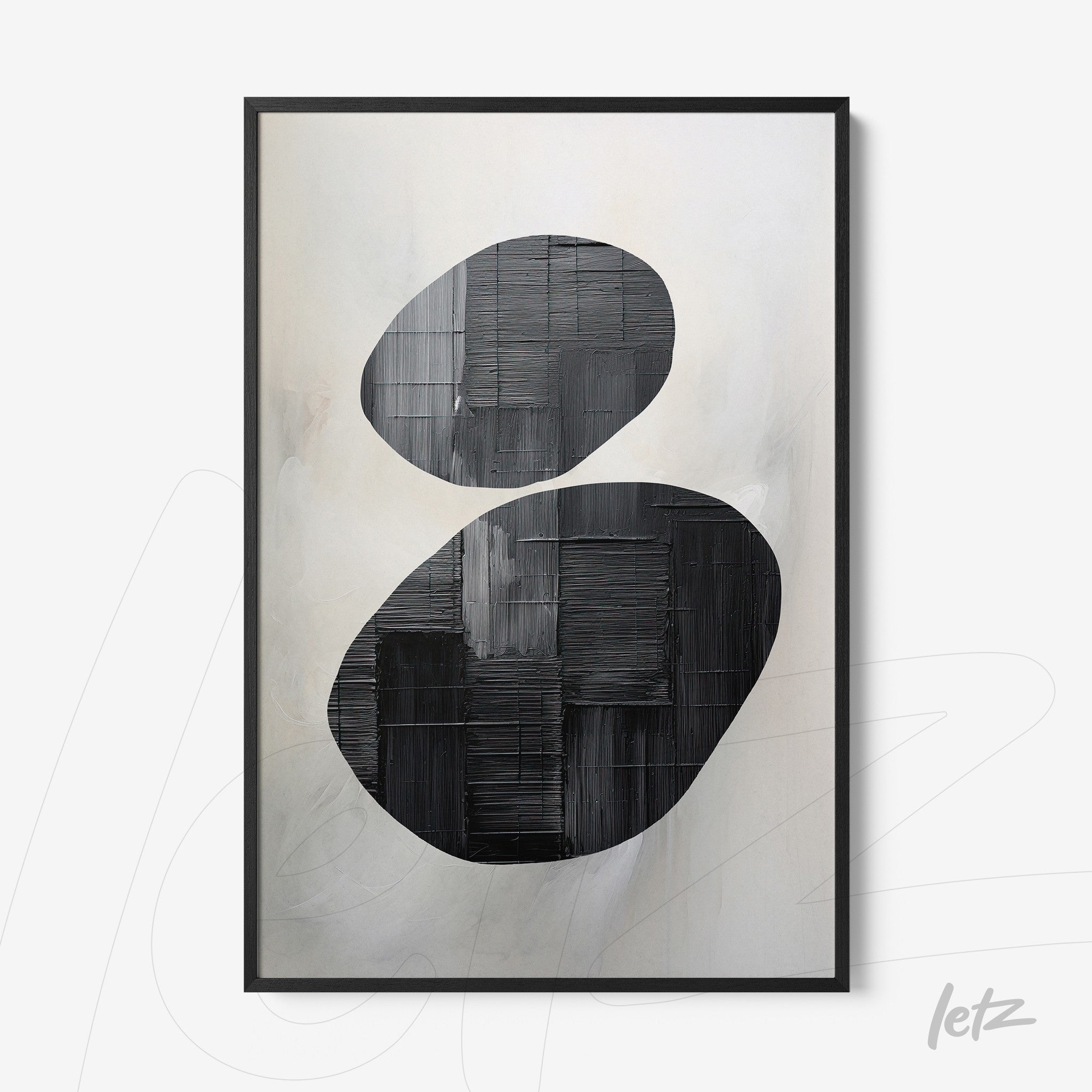 abstract wall art featuring two oval black shapes against a light textured background