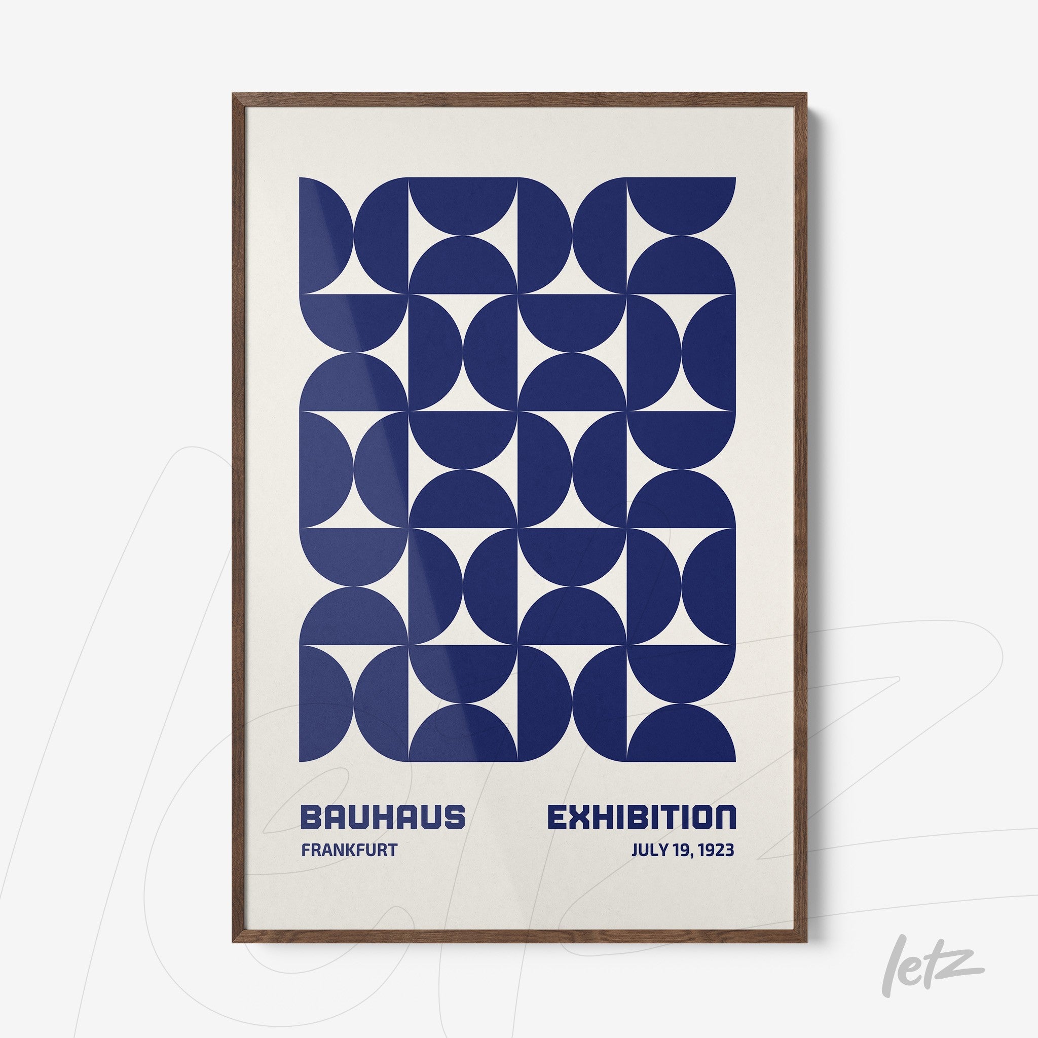 poster featuring blue geometric design and text 'bauhaus exhibition' with dark wood frame