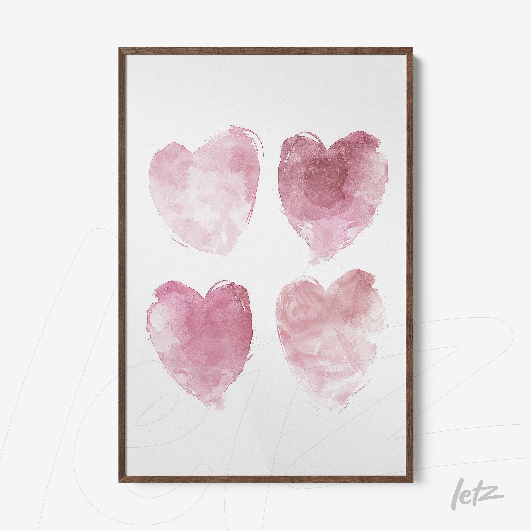 framed artwork featuring four watercolor hearts in shades of pink with a dark wooden frame