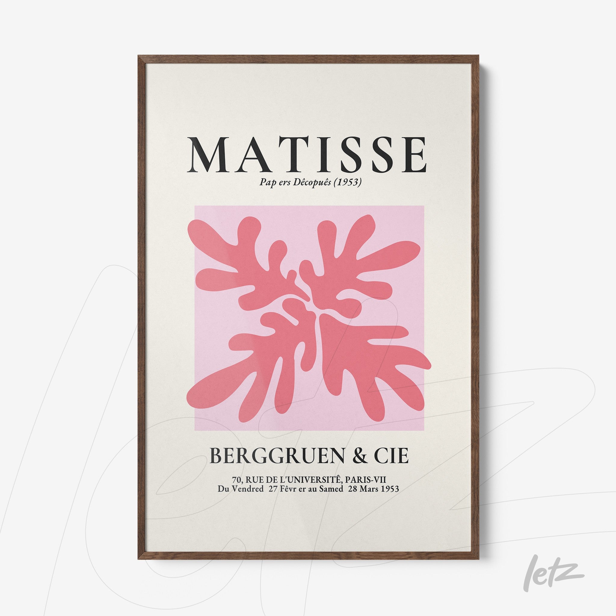 framed modern art piece featuring organic shapes in shades of pink on a light pink background with dark wood frame
