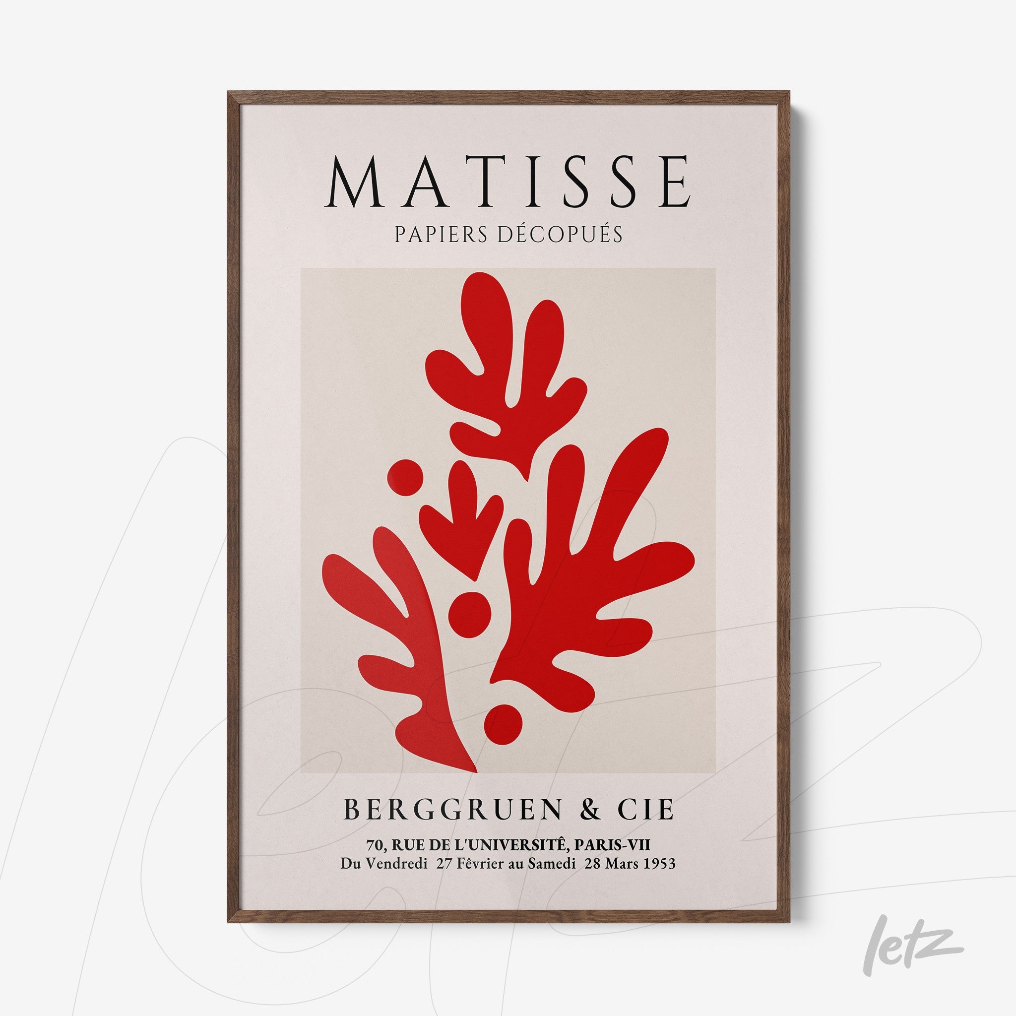 framed wall art featuring modern style red shapes on a light background with a dark wooden frame