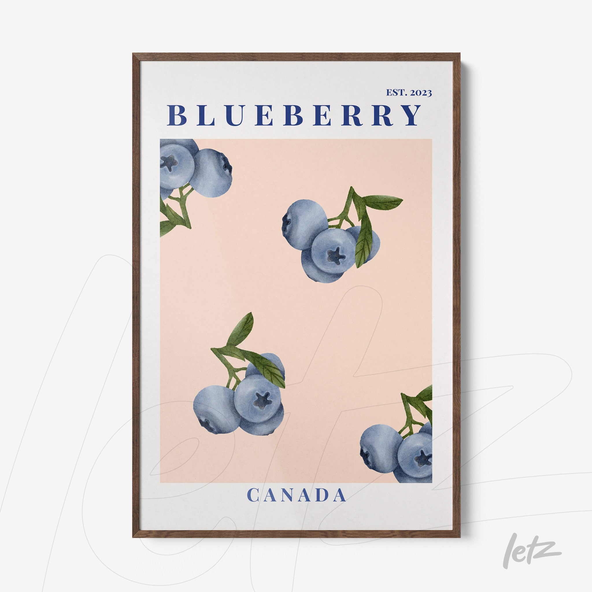 framed wall art featuring blueberries against a pink background with a dark wood frame