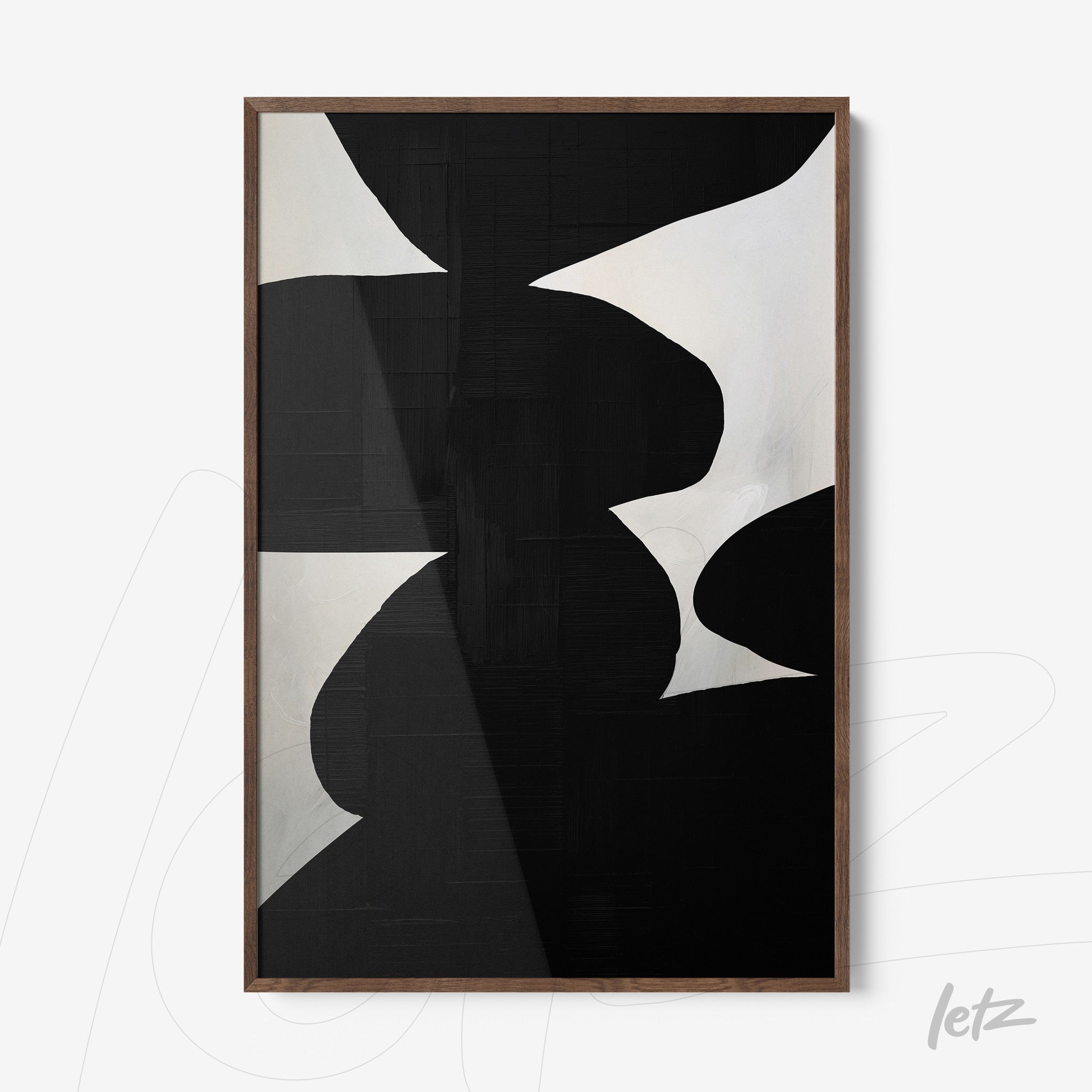 framed abstract art in black and white with dark wood frame and textured background