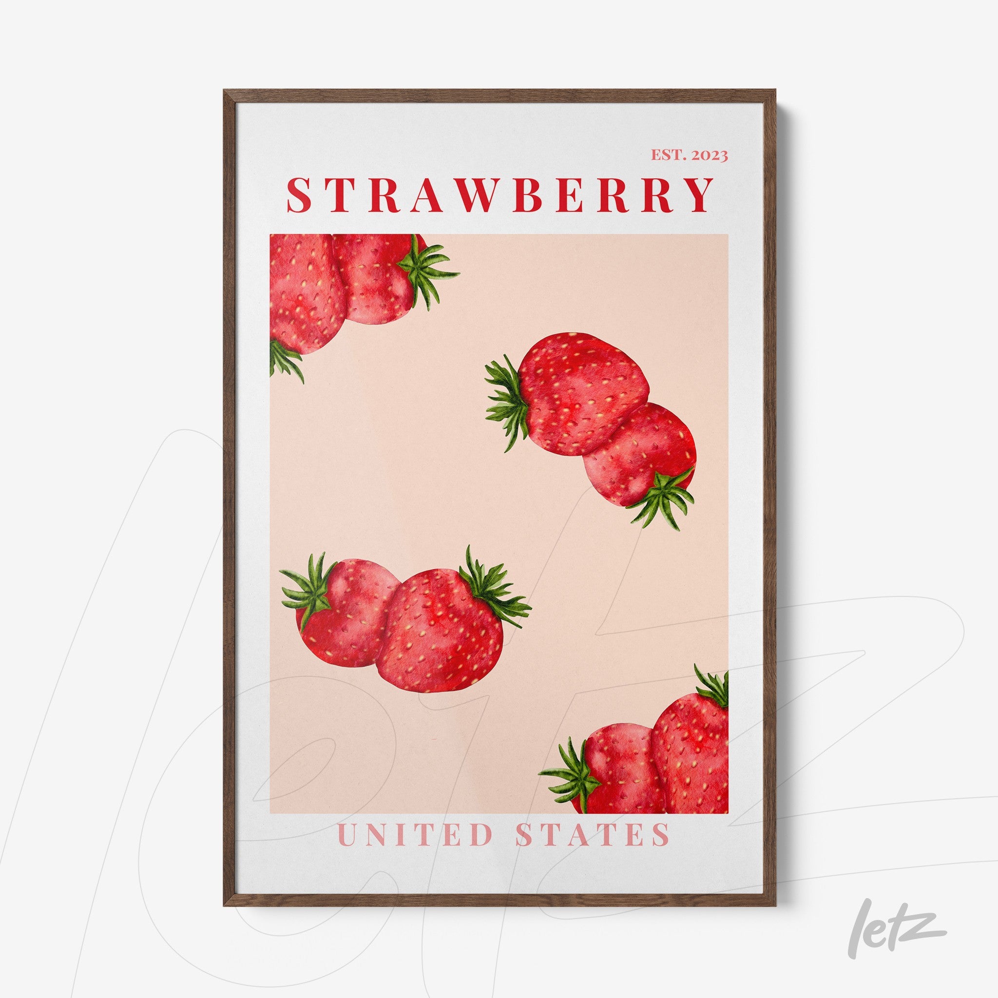 framed wall art featuring strawberries on a pink background with dark wood frame