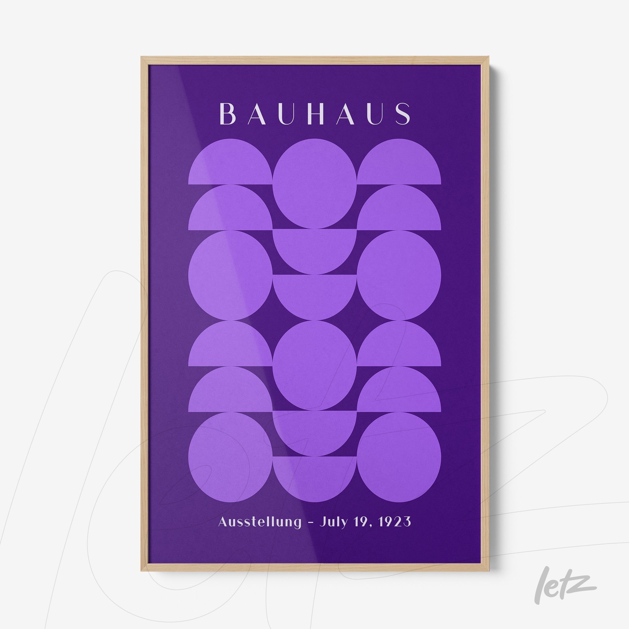 poster print with geometric Bauhaus-style art in shades of purple with light wood frame