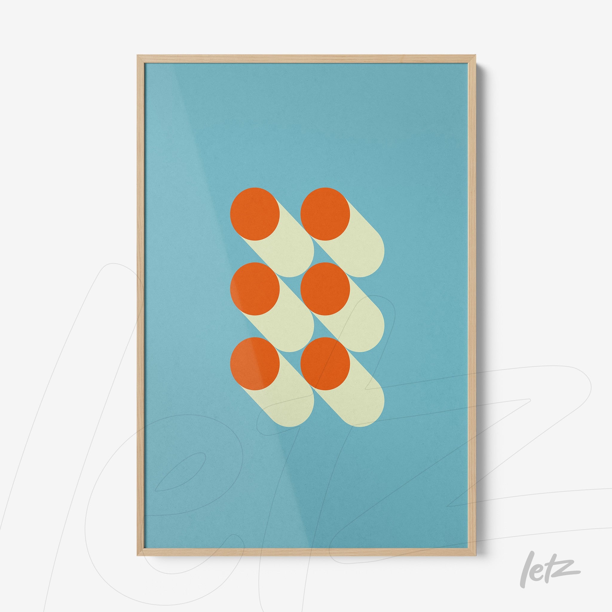 poster featuring geometric art of orange circles on a blue background with light wooden frame