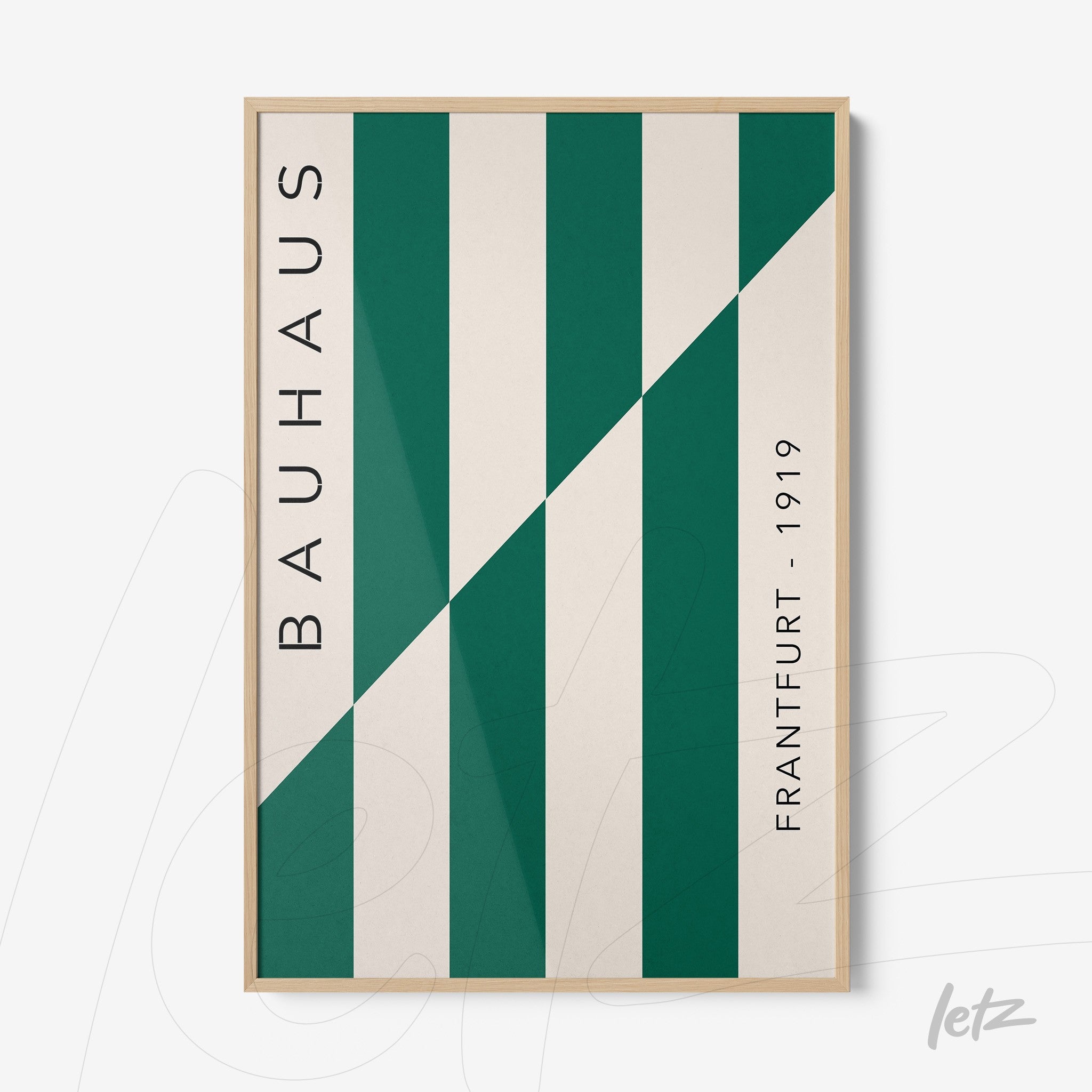 poster featuring geometric design of green and white stripes in a light wood frame, with bauhaus text on the side