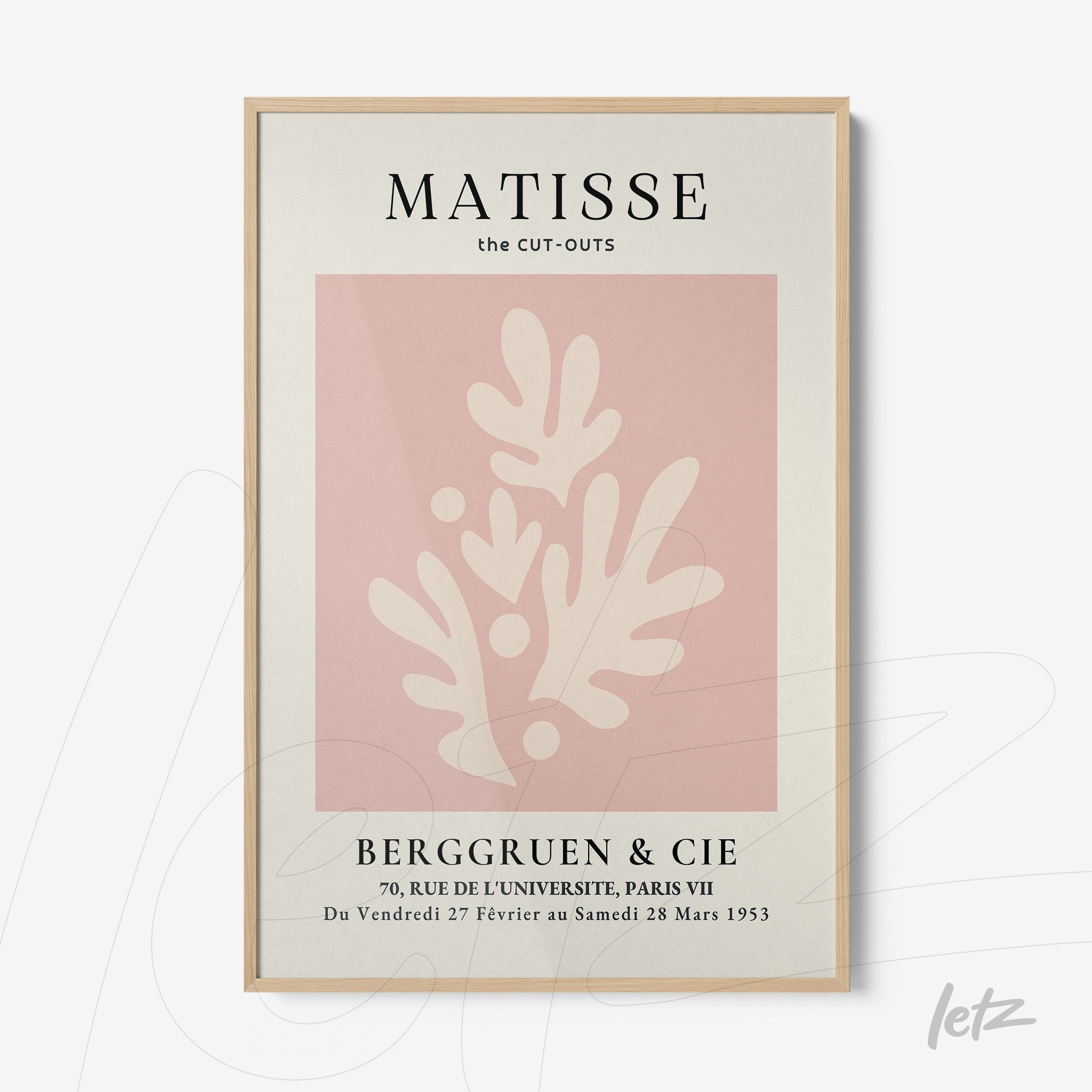 framed modern art print on pink background featuring abstract white shapes with light wood frame
