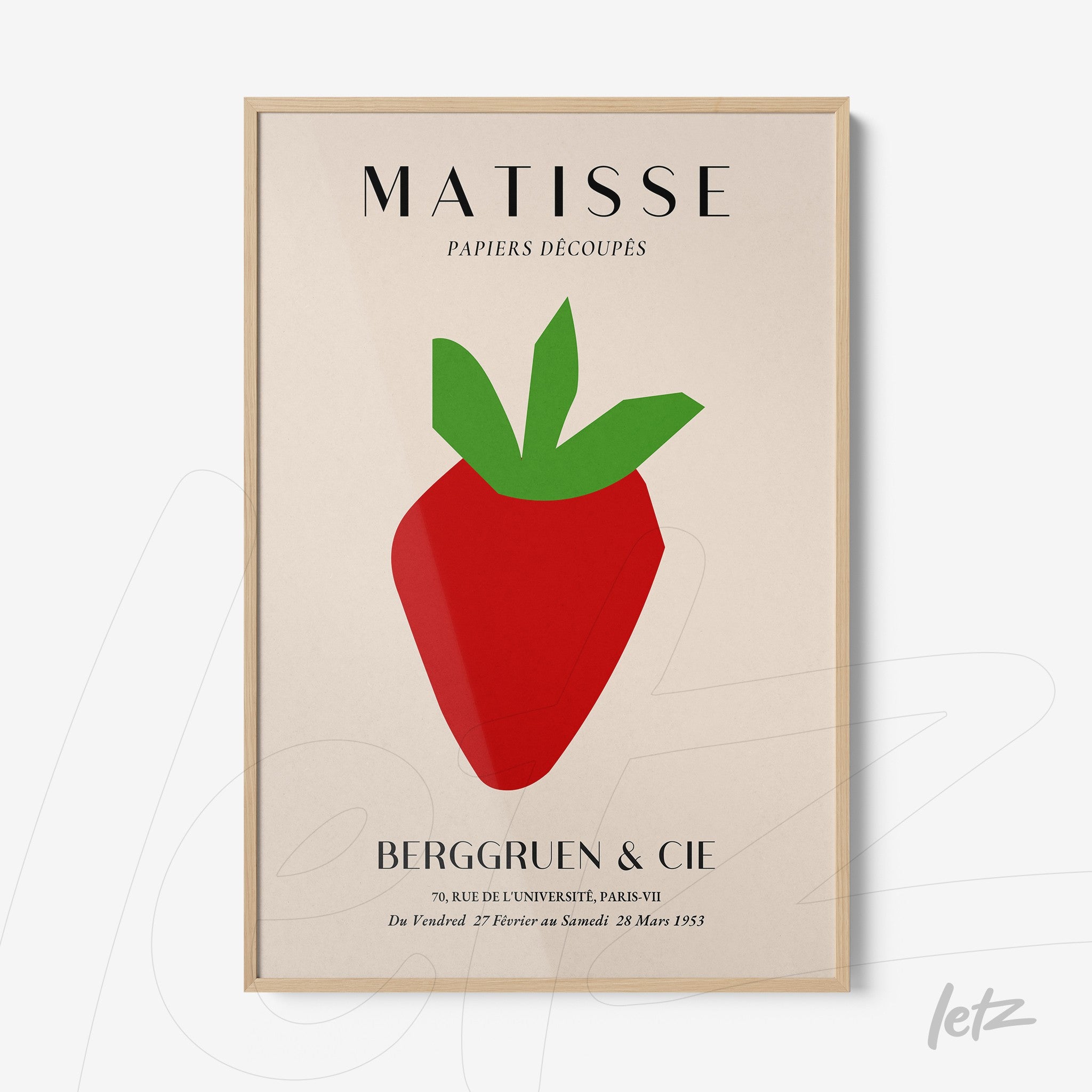 framed modern art print of a strawberry in minimalist design with beige background and light wood frame