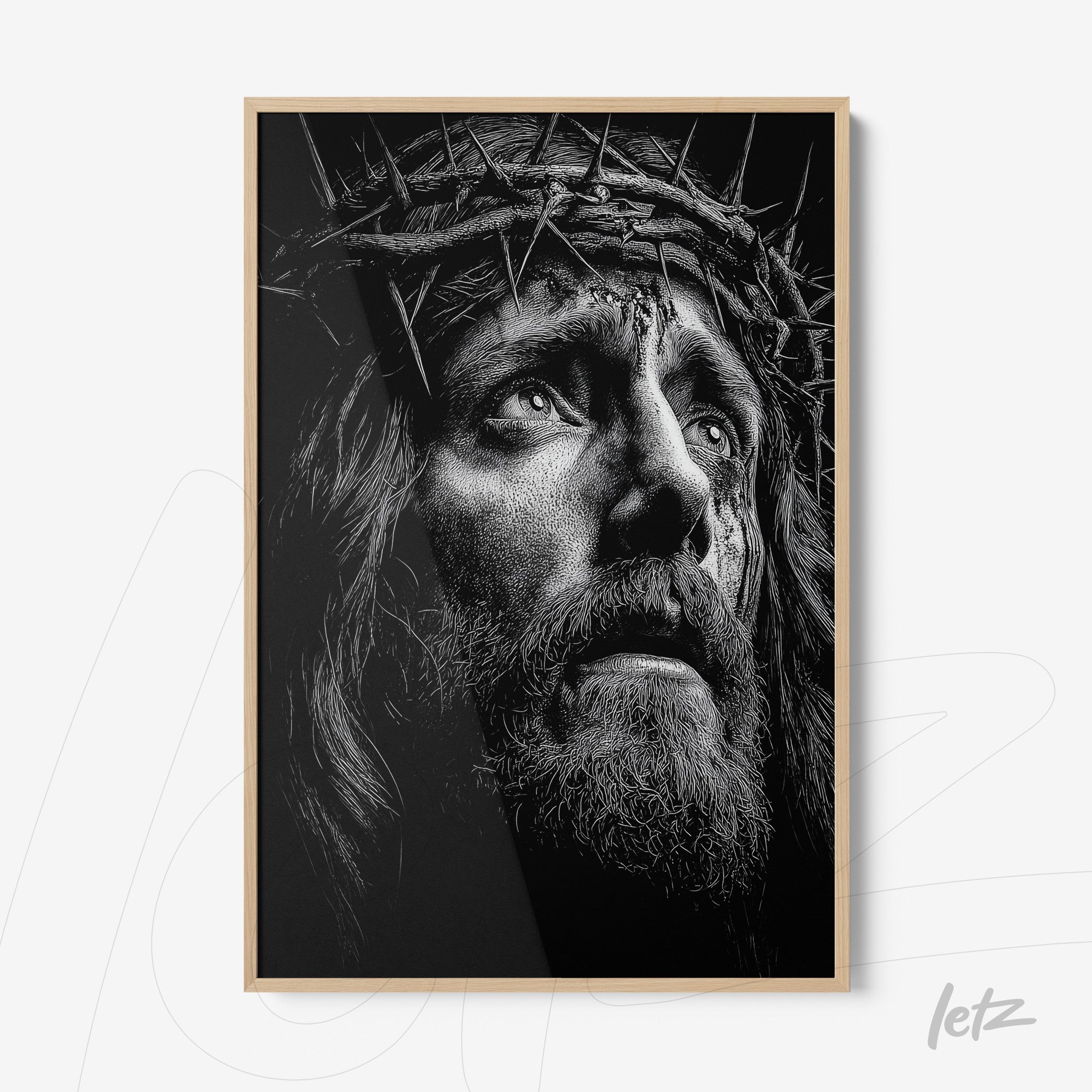 framed black and white portrait of Jesus Christ wearing a crown of thorns with light wood frame