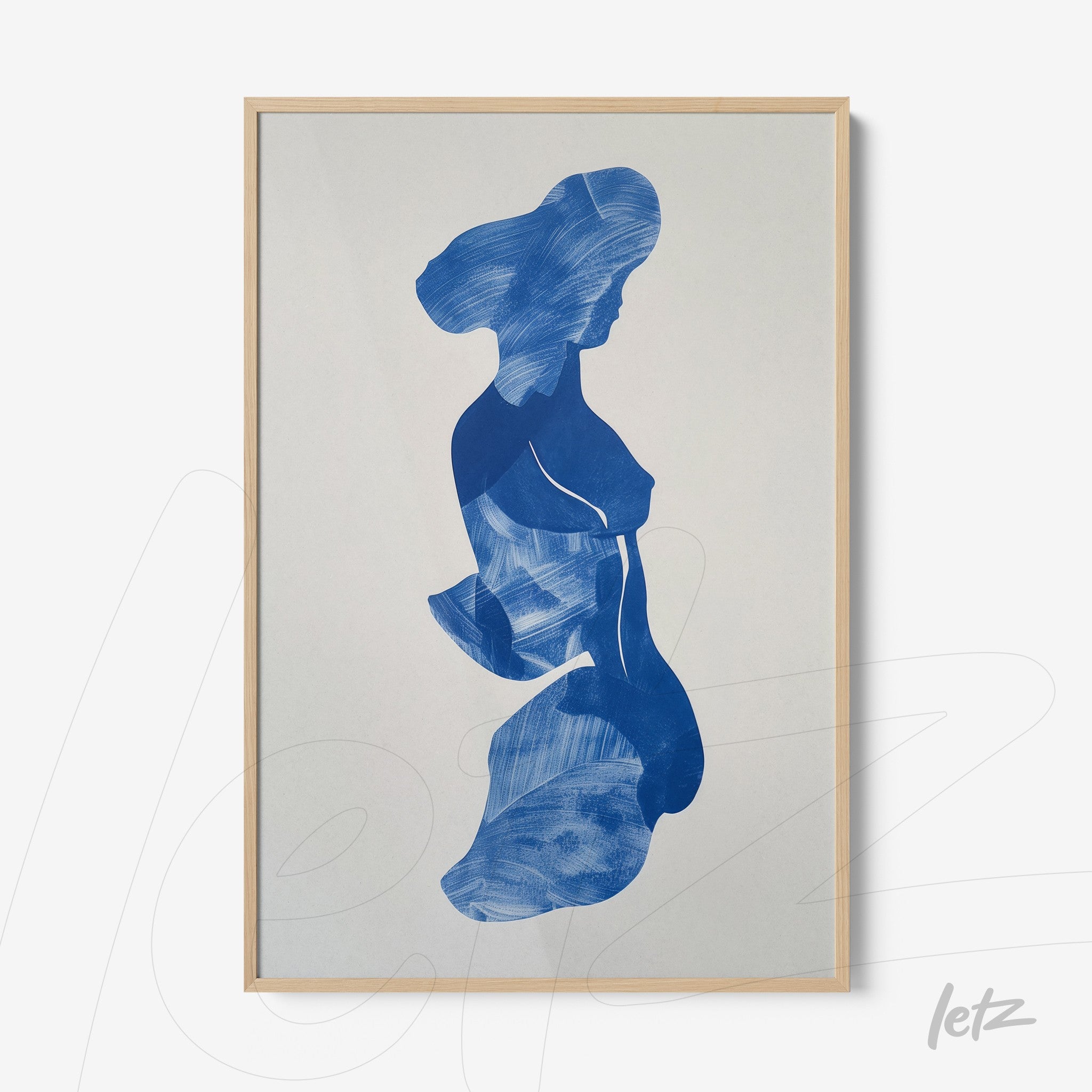 framed wall art featuring an abstract blue silhouette of a woman in light wood frame