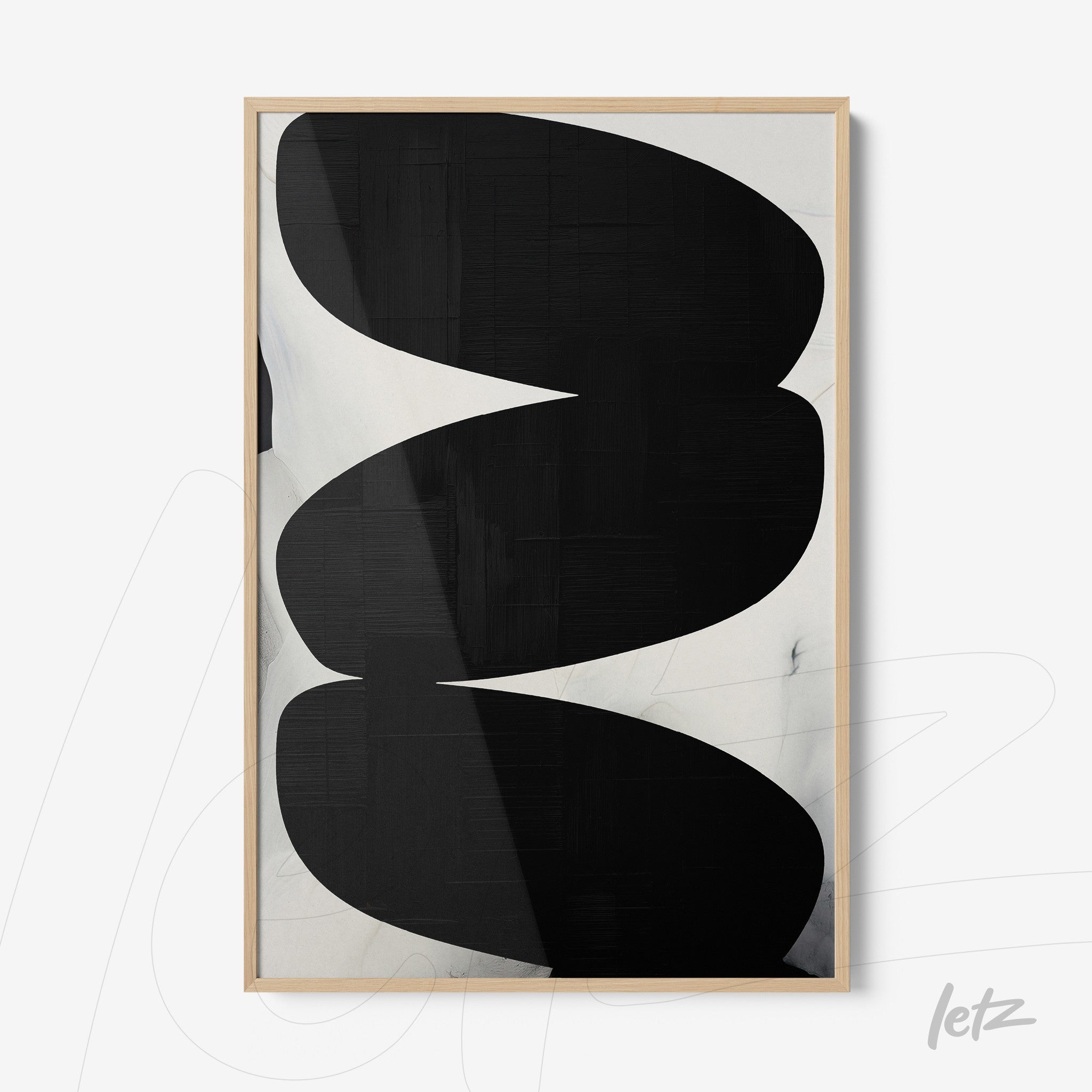 framed artwork featuring abstract black and white shapes against a textured background