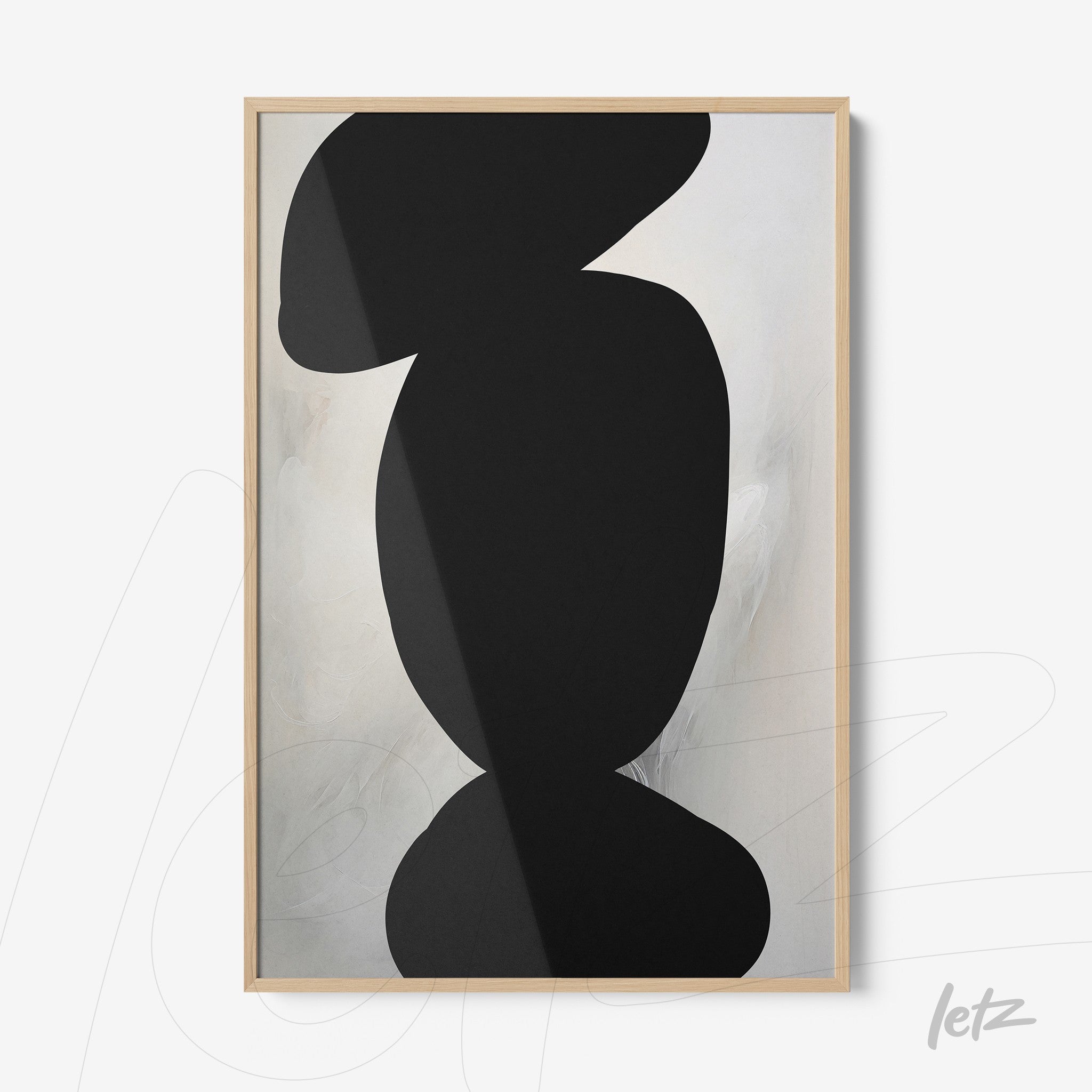 framed abstract art in black on light background with natural wood frame