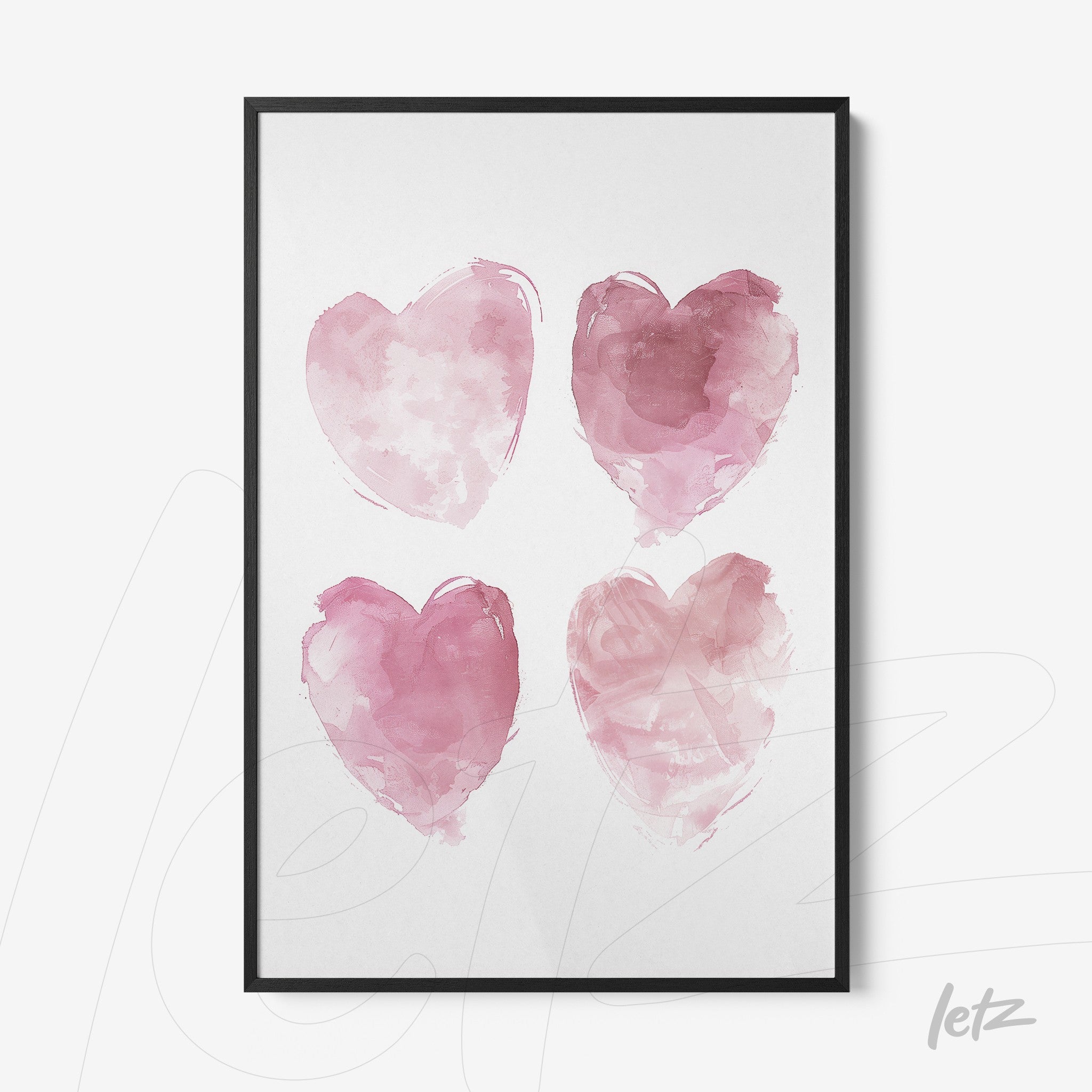 framed wall art featuring four pink watercolor hearts with a black frame