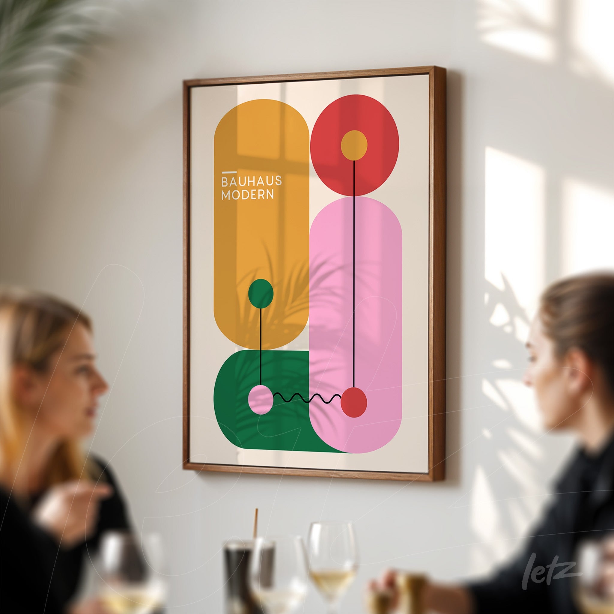 poster featuring modernist art with colorful geometric shapes and lines in a wooden frame on a white wall