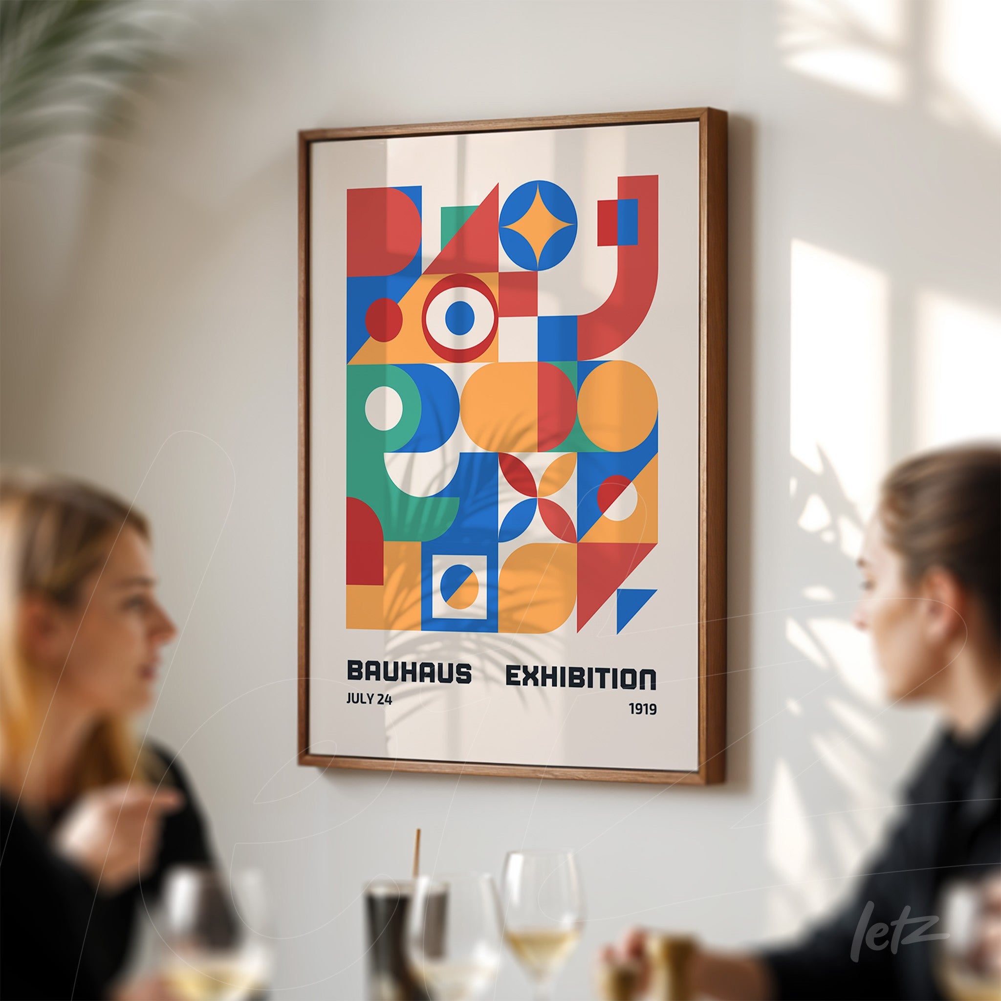 poster with colorful geometric art inspired by the 1919 Bauhaus exhibition in a dark wood frame