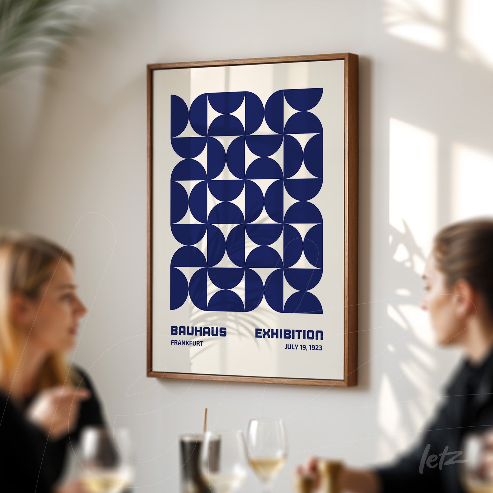 geometric symmetrical design of Frankfurt Bauhaus exhibition 1923 poster in wooden frame displayed on light wall