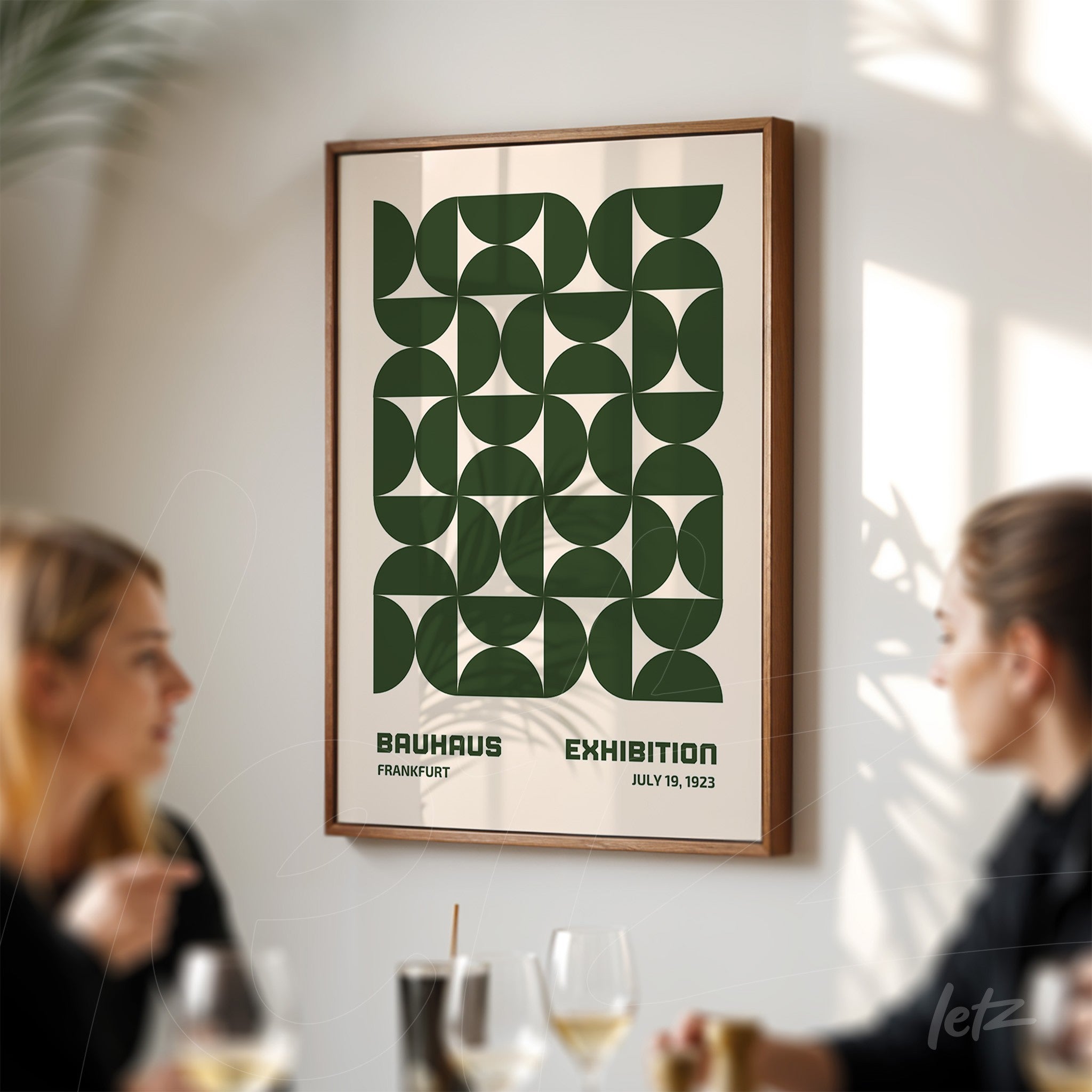framed poster print with green geometric Bauhaus design, displayed on a light-colored wall
