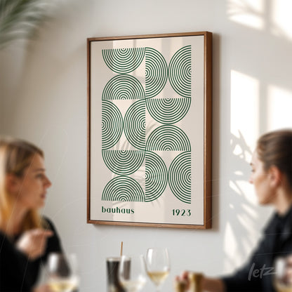 framed geometric bauhaus-inspired art with green concentric circles and a wooden frame