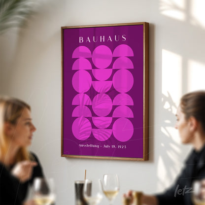 geometric patterned wall art in pink on purple background with wooden frame, featuring text 'Bauhaus Ausstellung - July 19, 1923'