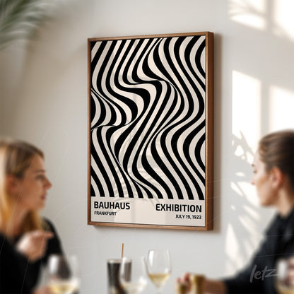 framed poster with black and white abstract geometric pattern displayed on a white wall