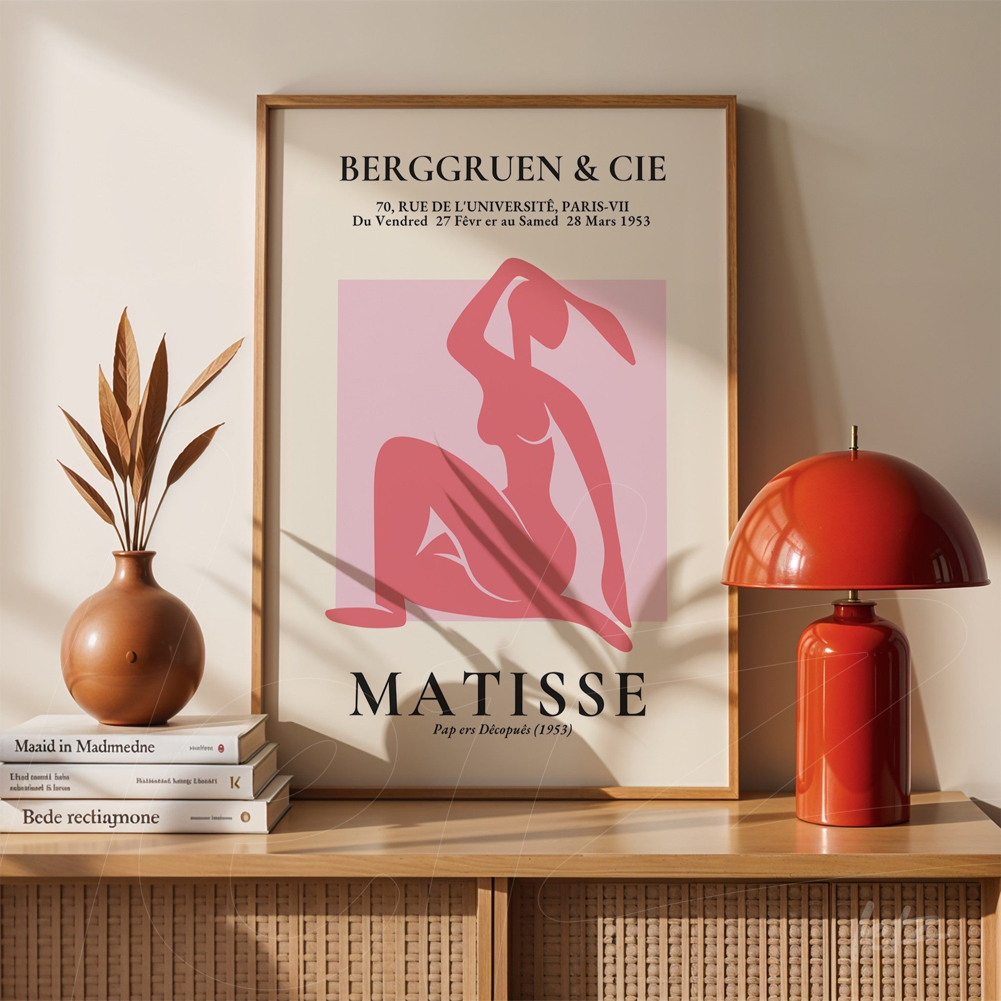 framed wall art featuring henri matisse's work in pink background displayed on wooden shelf with minimalistic decor