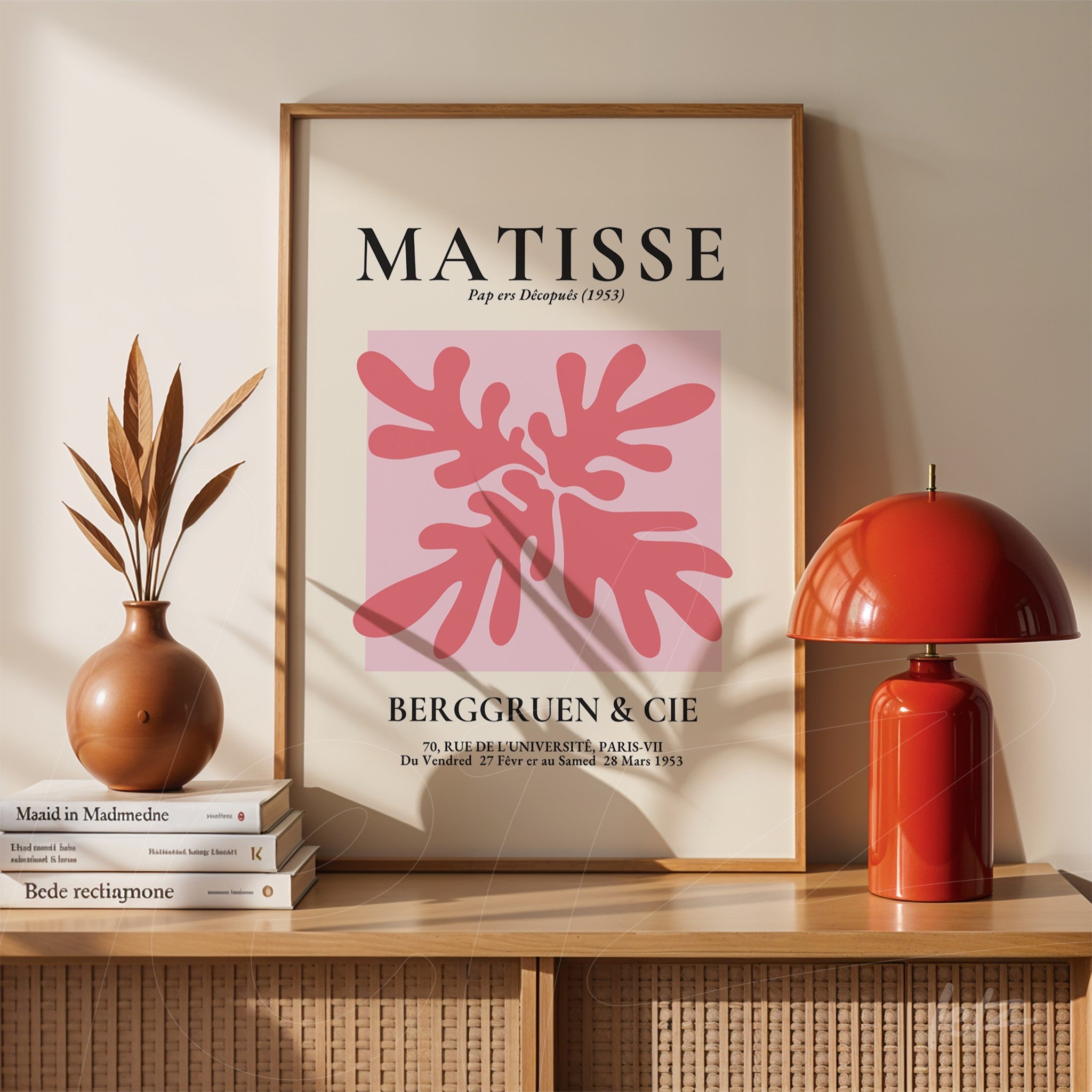 decorative wall art featuring modern pink and red tropical plant illustration in white frame displayed in a wooden shelf setting with a red lamp