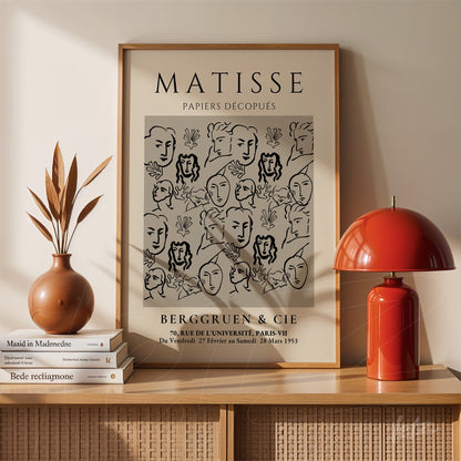 framed wall art featuring modern art by Matisse with stylized faces and floral elements on light background