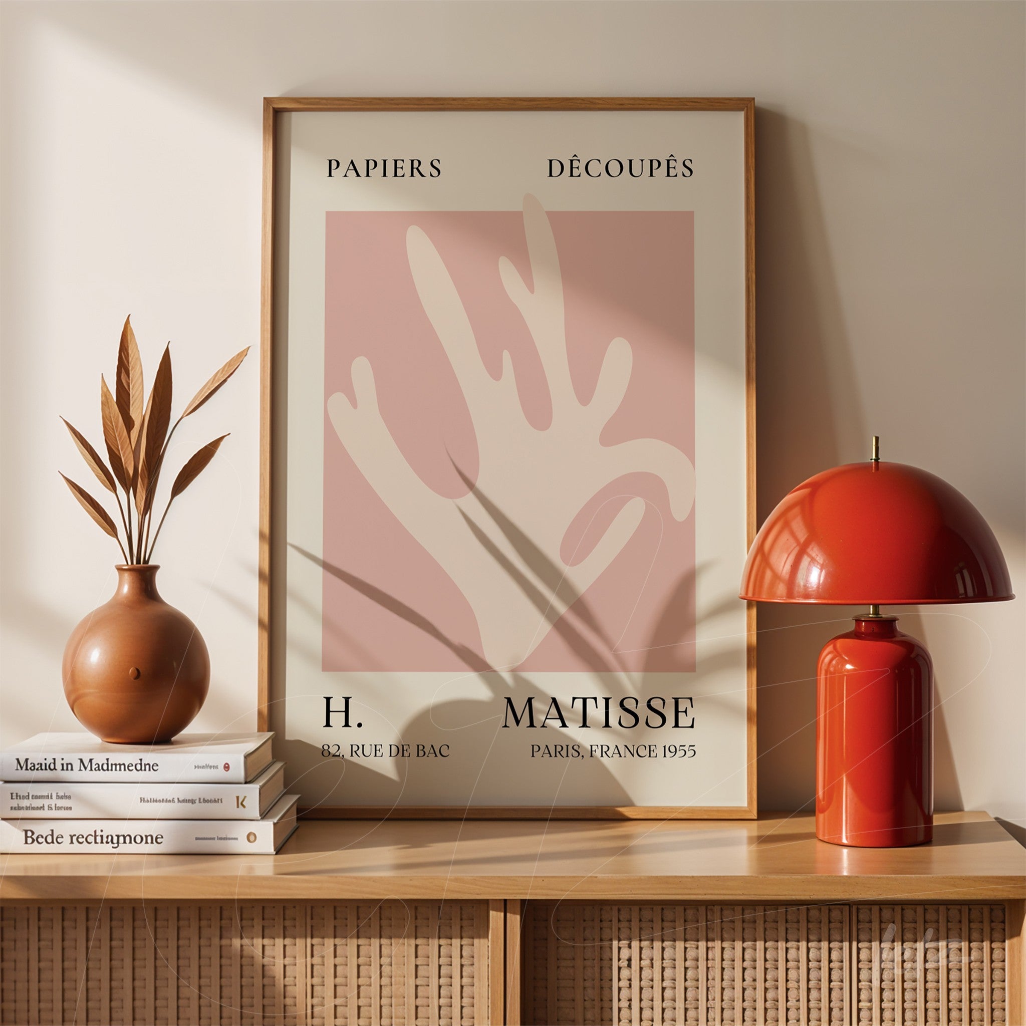 framed modern art featuring abstract shapes on soft pink background with light wood frame