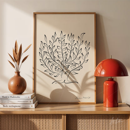 framed line art drawing of leaves displayed with a ceramic vase and red lamp on wooden shelf