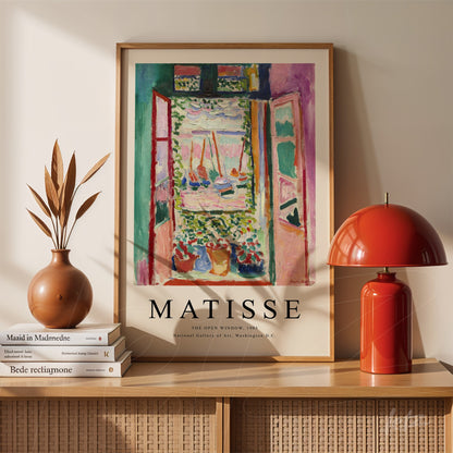 framed artwork depicting an open window with a vibrant landscape featuring boats
