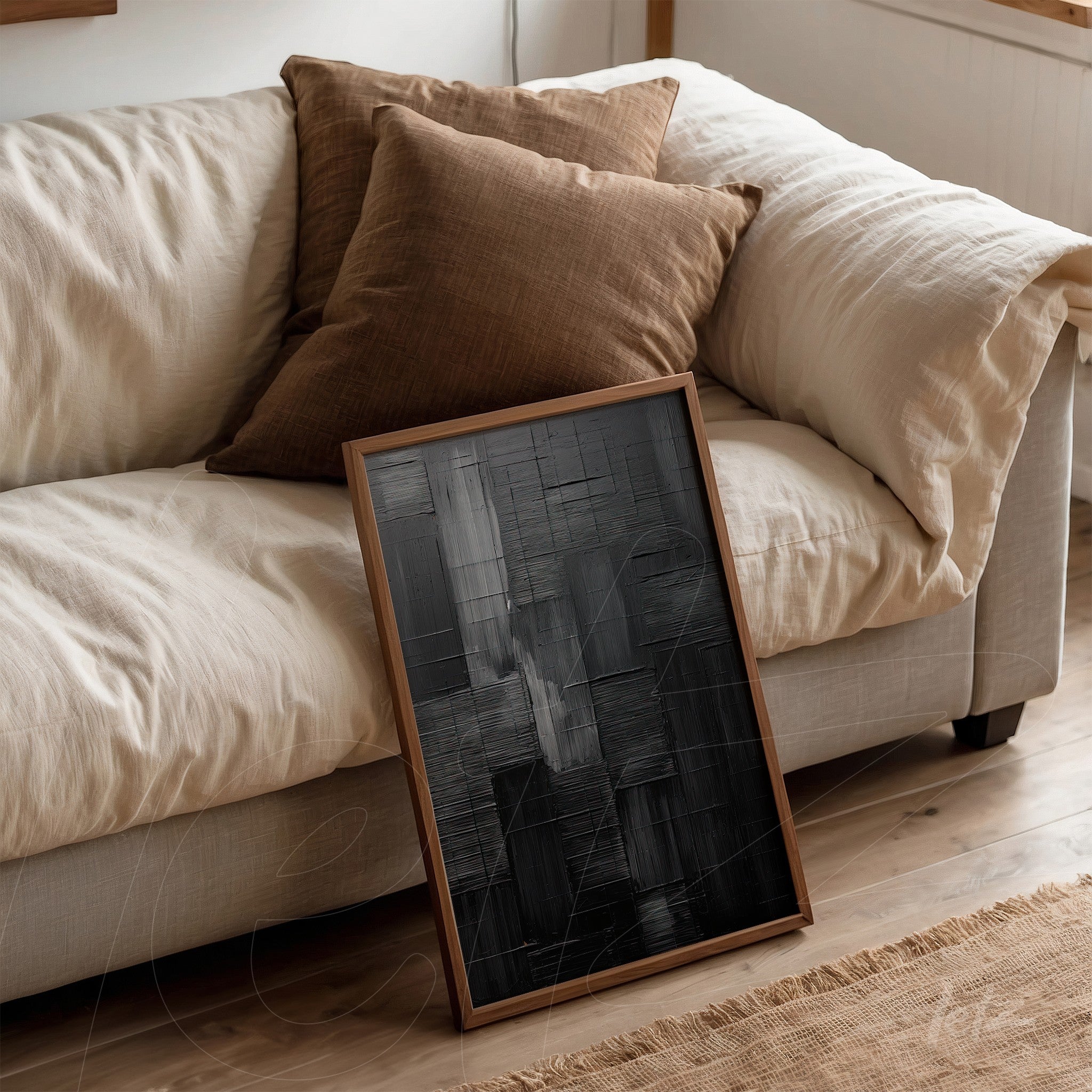 abstract wall art with black texture leaning on light sofa