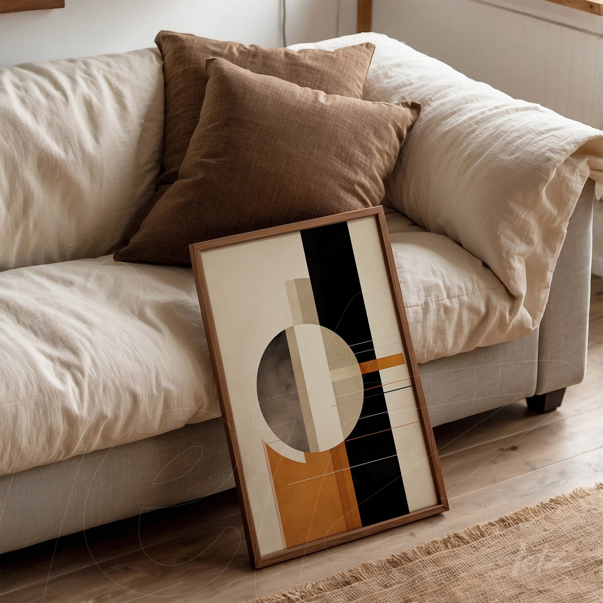 modern decorative wall art featuring geometric shapes in orange, black, and gray in light wood frame, leaning against a sofa with brown cushions