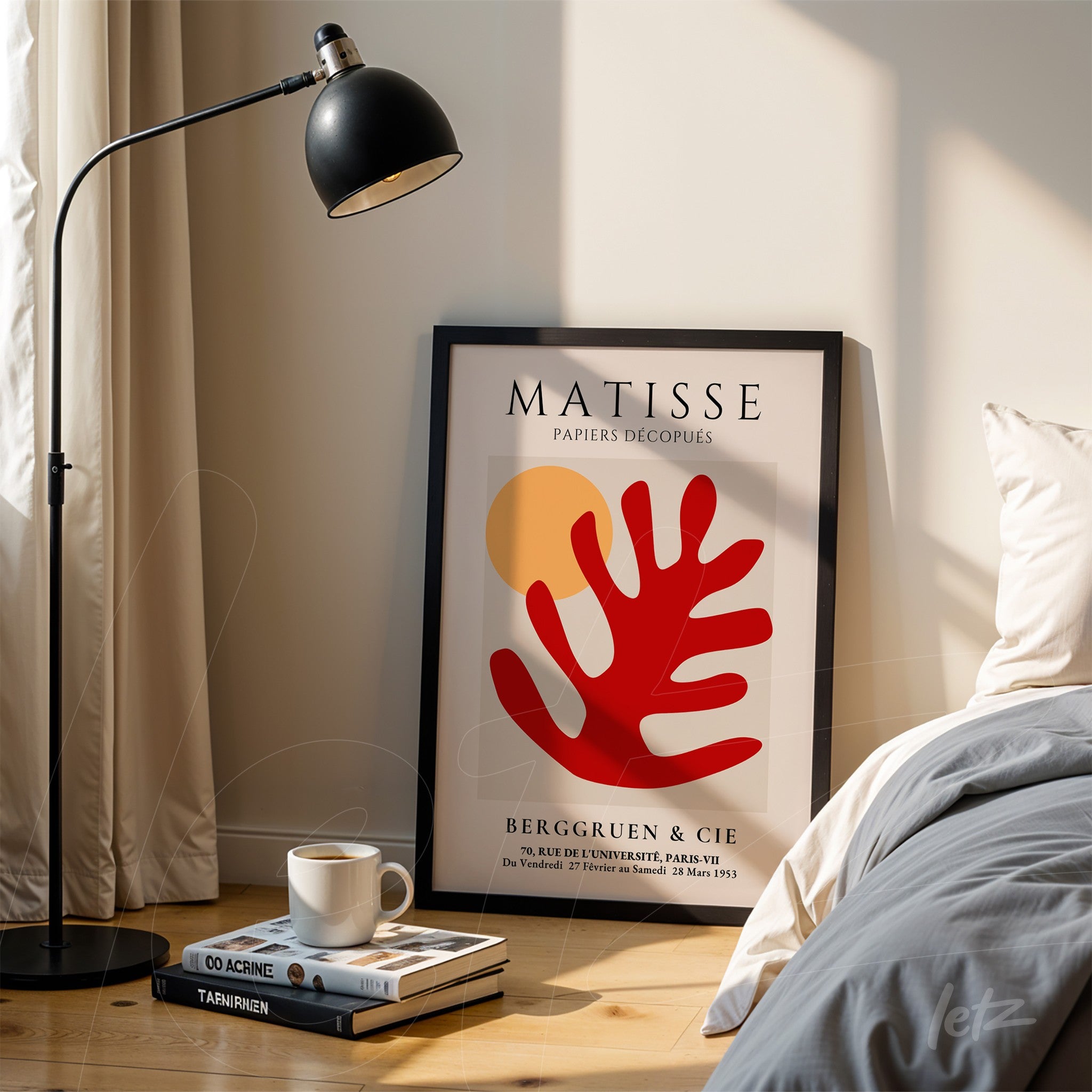 decorative wall art featuring modern cut-out style by Matisse in a thin black frame propped beside a floor lamp and light-colored bedding