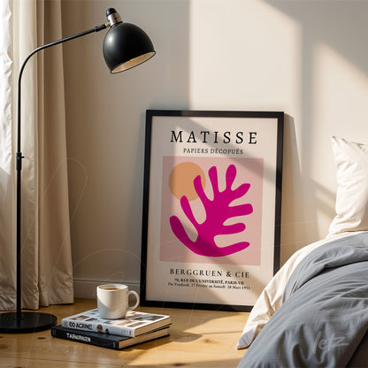 decorative wall art featuring matisse artwork in a black frame displayed beside a lamp in a well-lit room