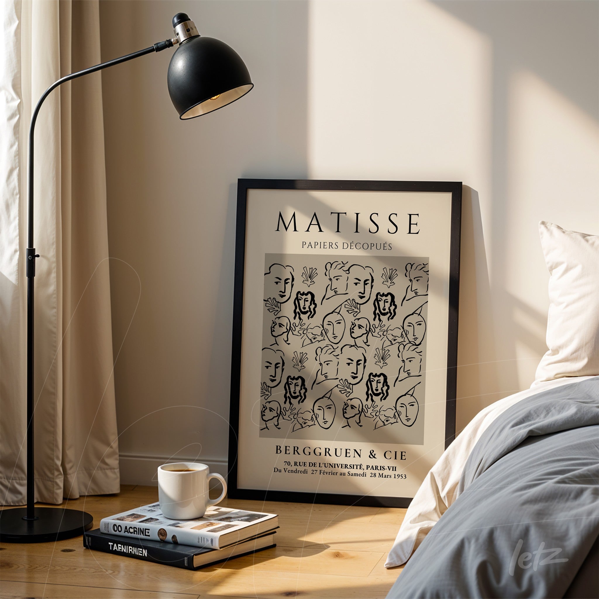 framed line art print featuring stylized faces in a black frame leaning next to a floor lamp in a bright setting