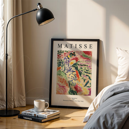 framed art inspired by matisse titled 'la japonaise' leaning next to a modern lamp