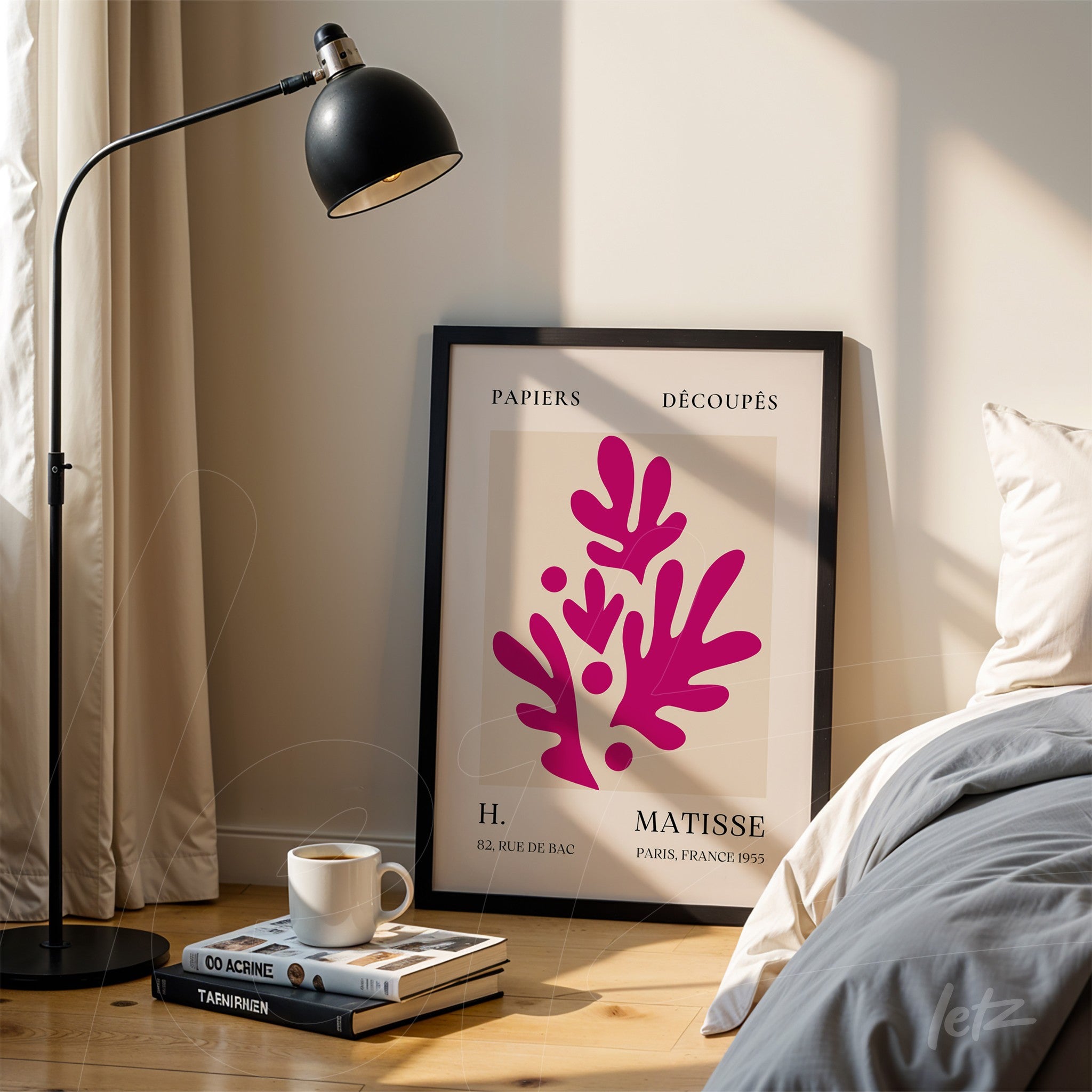 decorative wall art inspired by Matisse in black frame next to lamp and bed, featuring vibrant pink shapes