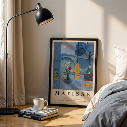 framed modern art print featuring still life elements placed next to a floor lamp in a cozy setting
