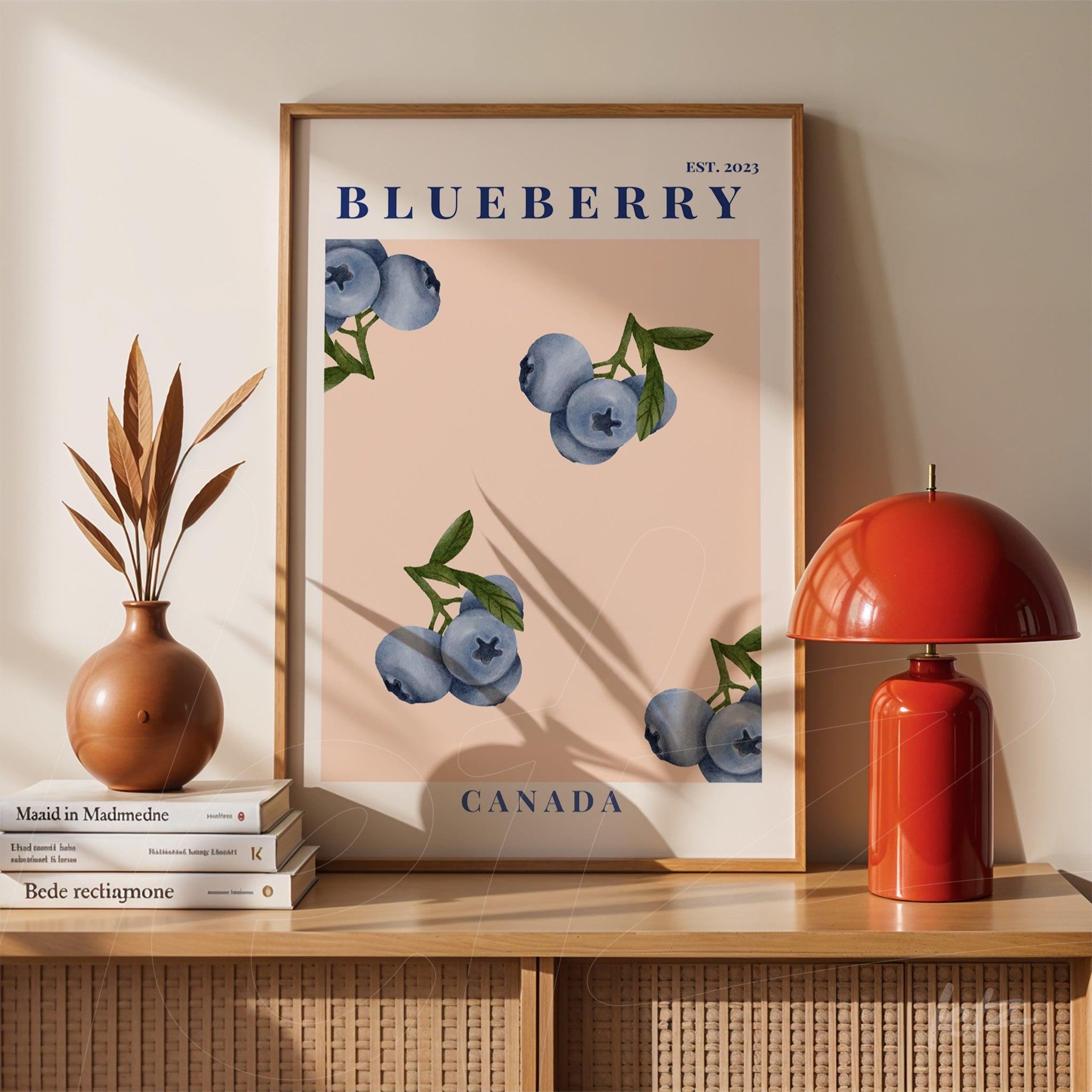 framed wall art featuring blueberries illustration on pink background with light wood frame