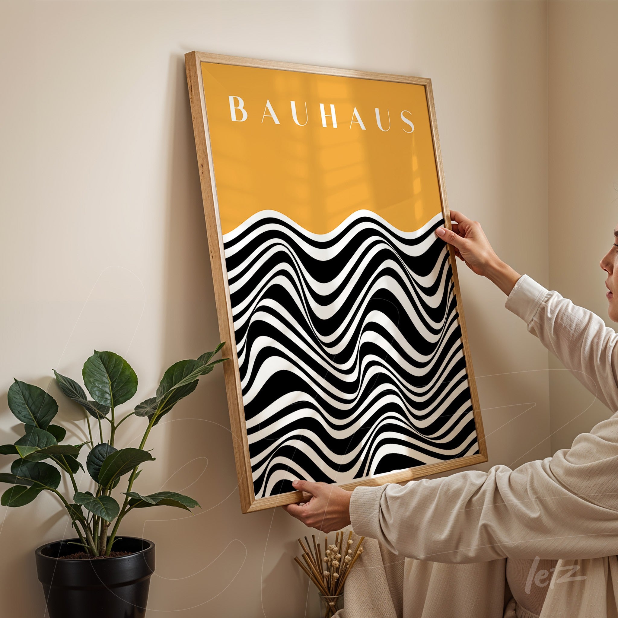 art print with black and white geometric waves on yellow background, light wood frame, displayed on a light-colored wall