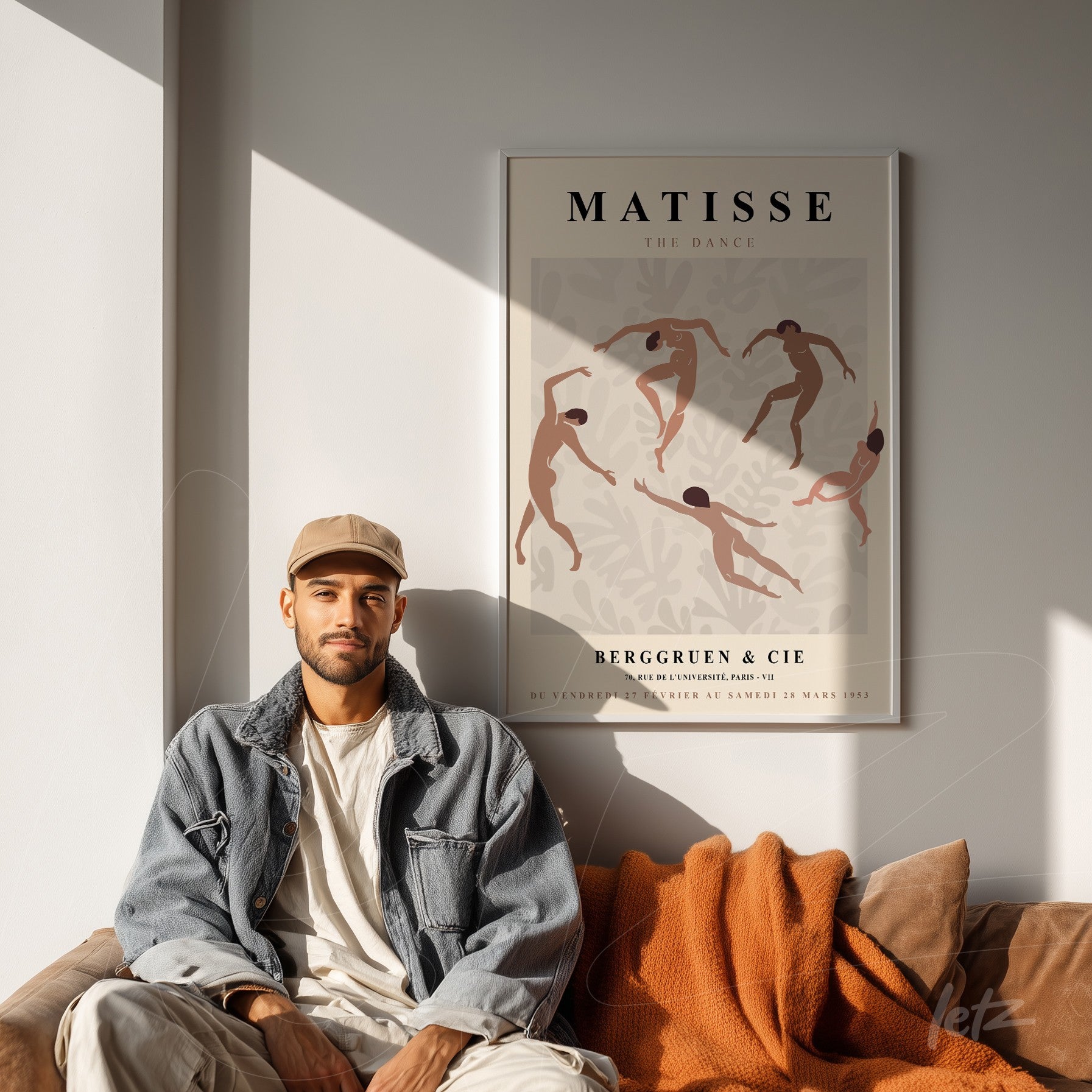 decorative artwork inspired by Matisse featuring dancing figures in earthy tones displayed above a sofa in a bright setting