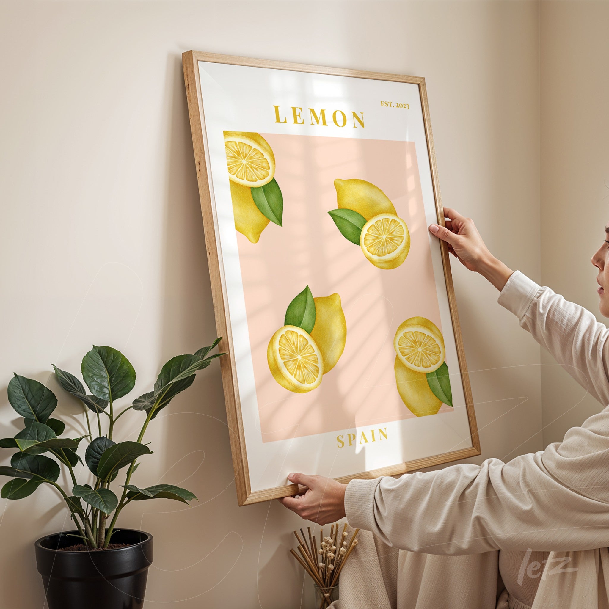 poster with lemon illustrations on pink background and light wooden frame