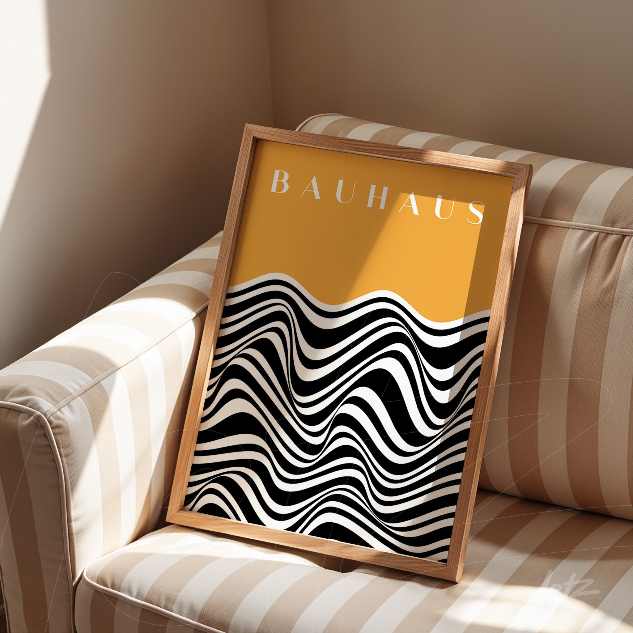 framed modern art with black and white wavy pattern on bright yellow background, displayed on striped sofa