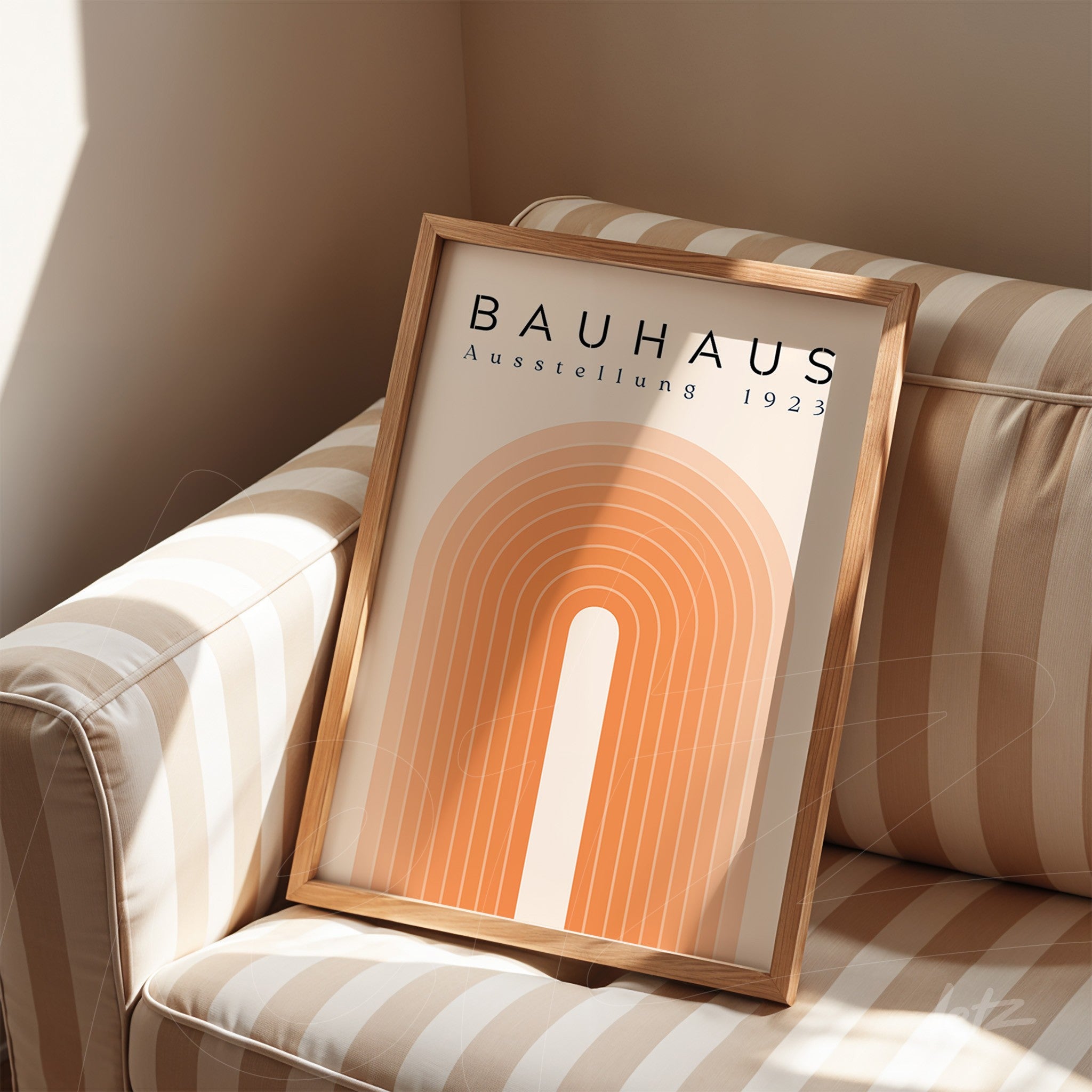 bauhaus style framed artwork featuring geometric design in light wood frame on striped sofa