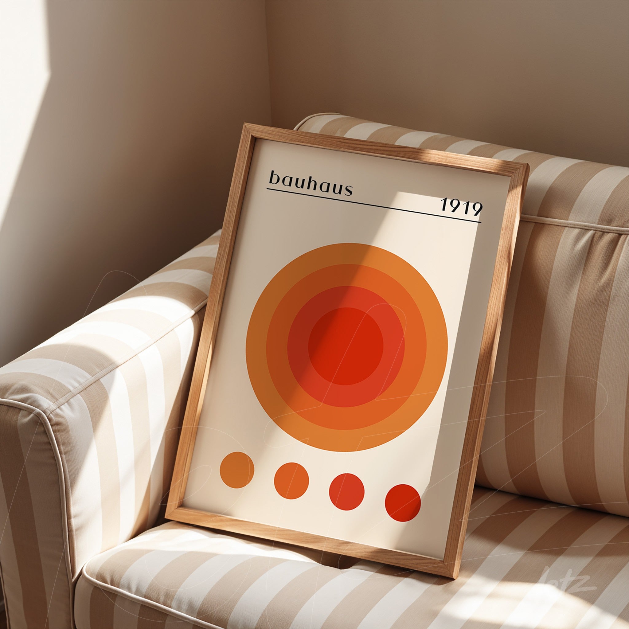 bauhaus style abstract art with concentric orange and red circles in a light wood frame