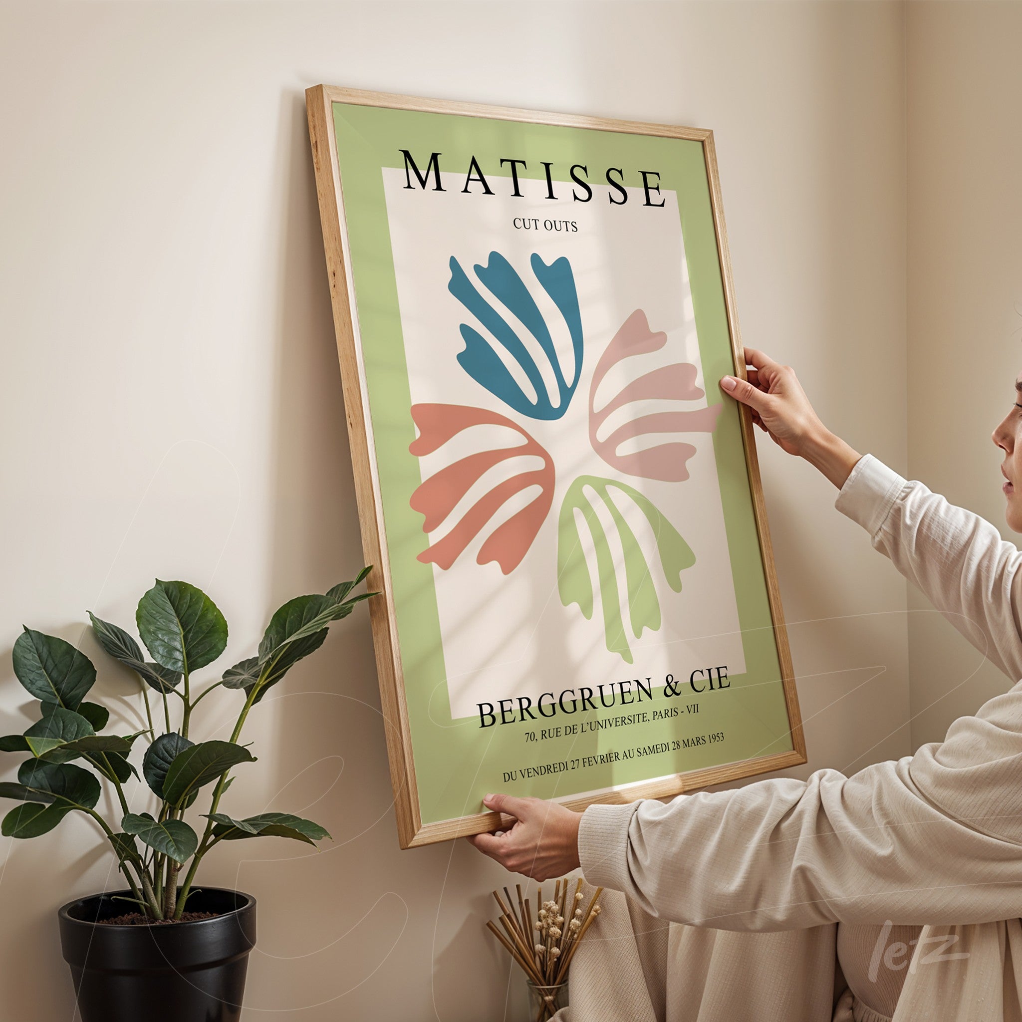 framed wall art featuring modern abstract design with colorful shapes on green background and light wood frame