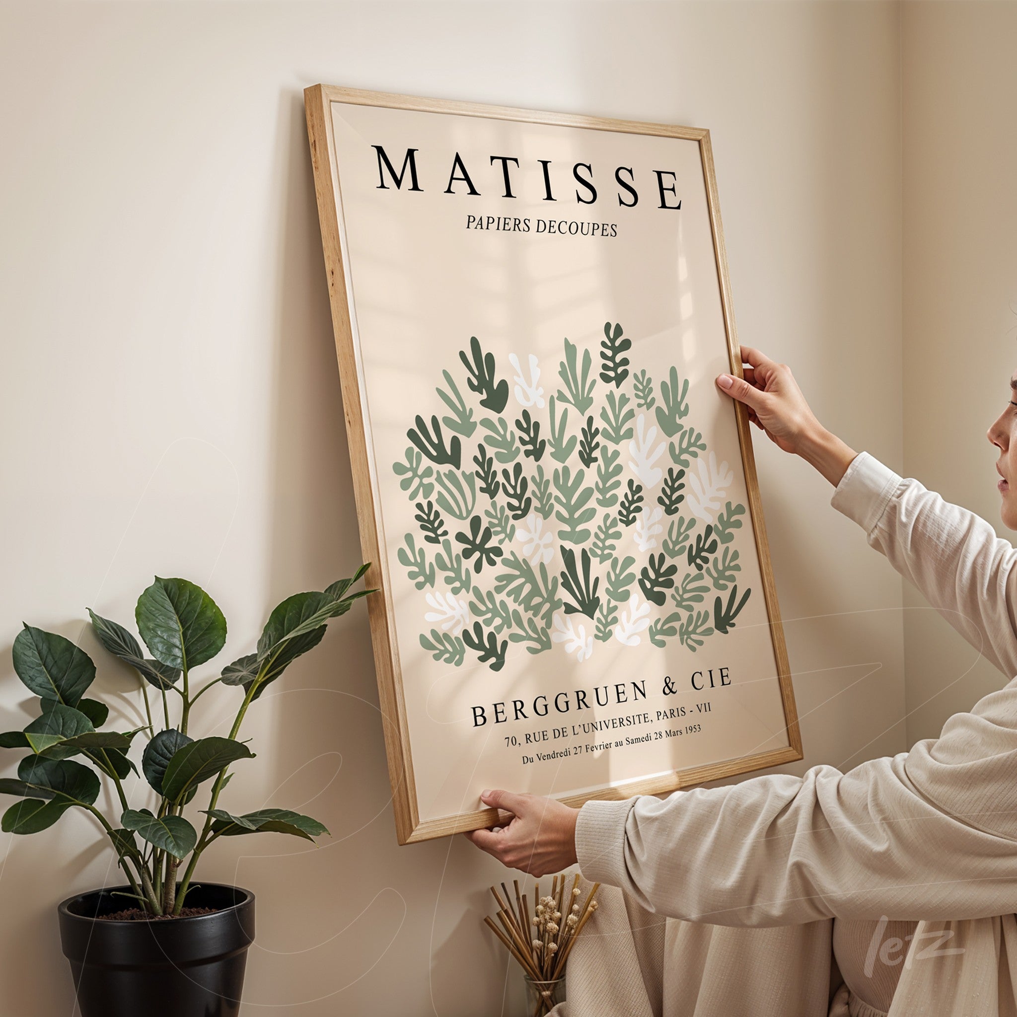 framed wall art featuring vintage style green leaves design with light wood frame and prominent artistic text