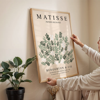 framed wall art featuring vintage style green leaves design with light wood frame and prominent artistic text